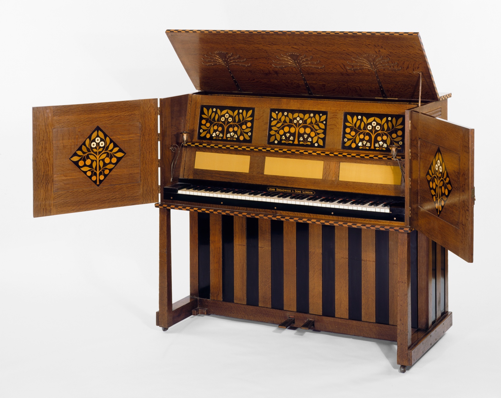 Wooden piano with cabinets inlaid with ivory and mother-of-pearl.