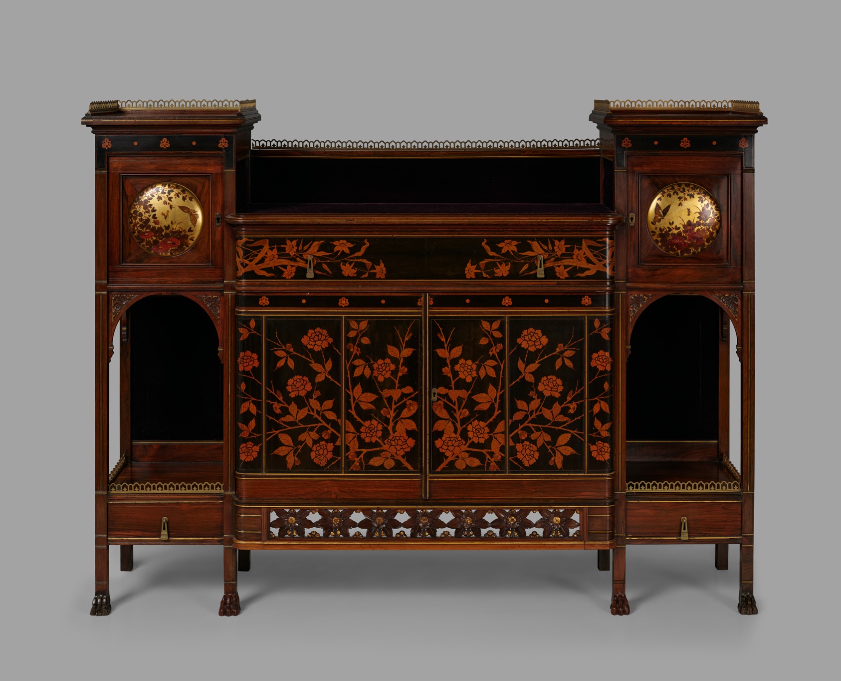 Wood cabinet with lighter wood floral design and brass.