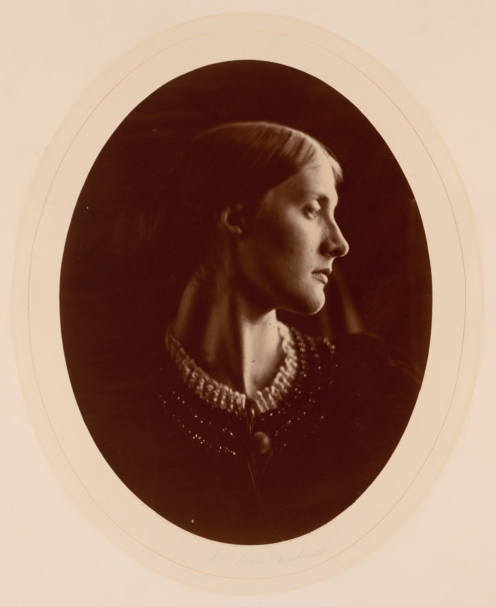 Black and white photograph of white woman, in profile, Victorian dress.