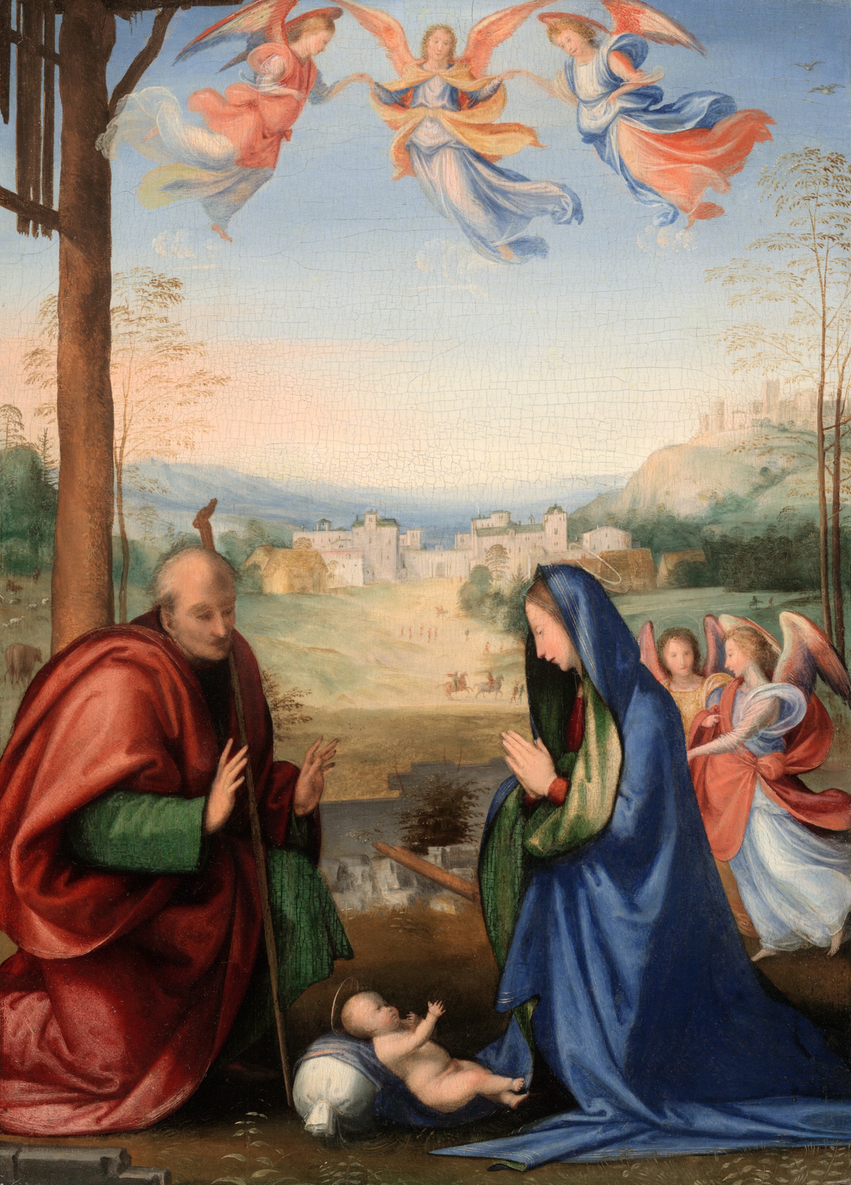 A light-skinned man in red and woman in blue sit with an infant between them, angels beside and above them, a small town in the background.