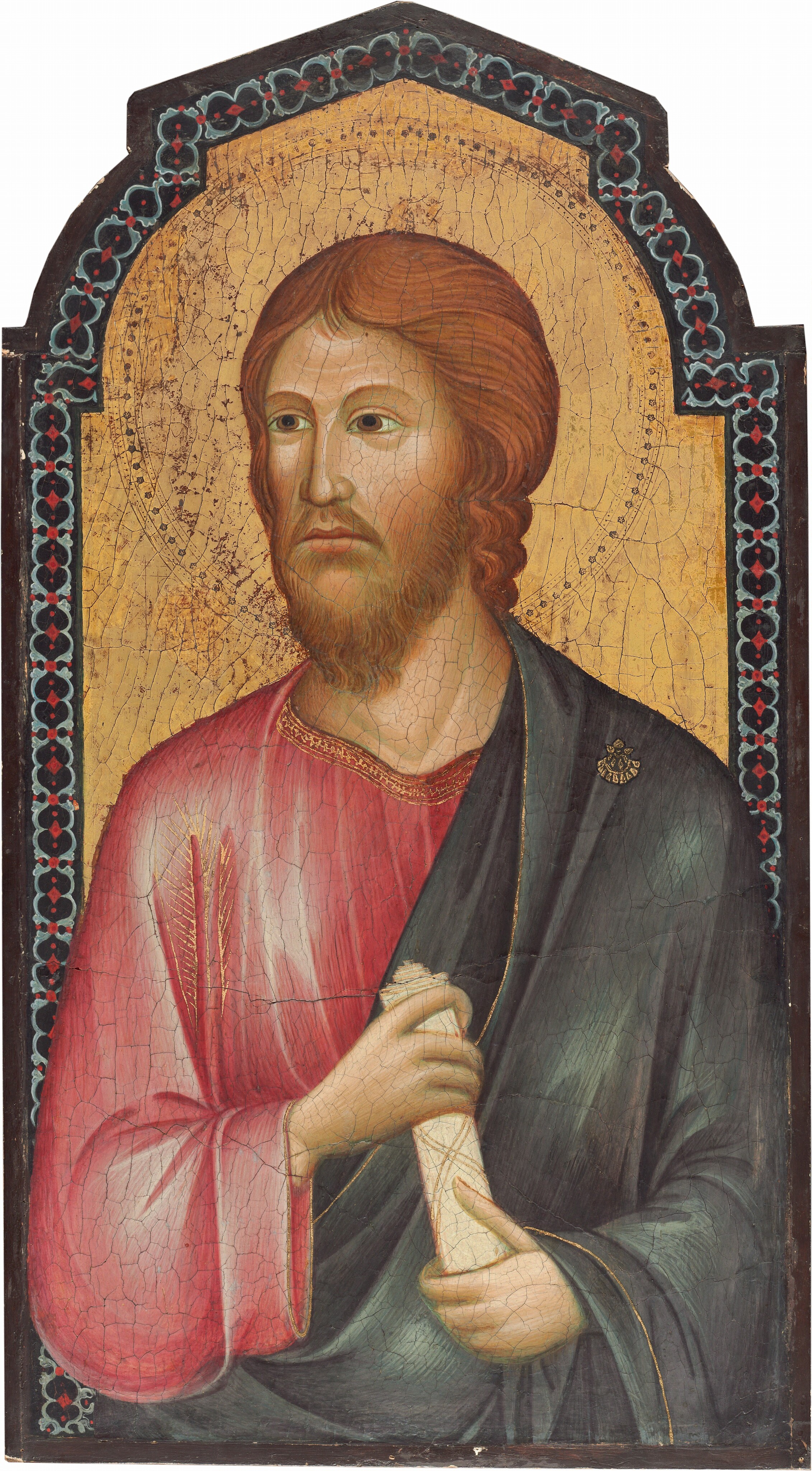This painting shows an upper body portrait of a man with his head turned slightly to the left. The man has light skin, reddish-blond, shoulder-length hair, thin eyebrows, a long nose, and a light brown beard and mustache. He is dressed in a light pink robe with a decorative gold border around the neckline and a dark blue cloth draped over his left shoulder. He is holding a rolled scroll with both hands. There is a thin circle around his head, perhaps indicating a halo. The background of the painting is gold, inside of a decorative border in black, red, and light blue.