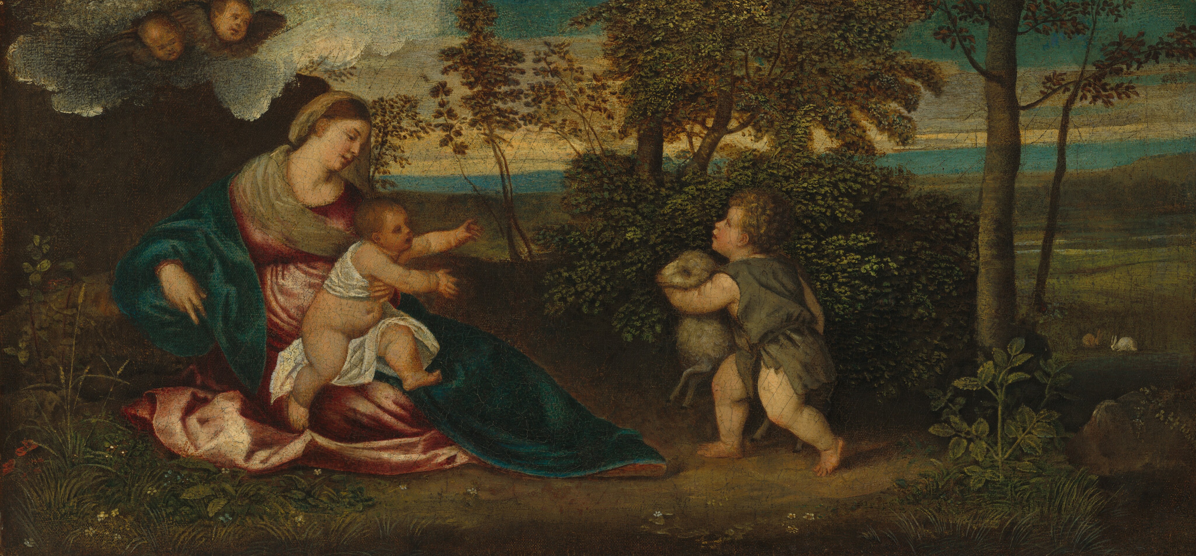 This painting depicts a woman seated outdoors with a baby in her lap on the left and a young child standing nearby on the right. The woman is sitting on the ground, while the baby is facing the right with their arms outstretched. The baby is partially wrapped in a white cloth. The woman has a serene expression and delicate facial features. She is wearing a green and red robe. The young child on the right is holding a small lamb and has curly blond hair. In the upper left corner of the painting, two cherubic faces peer down from a cloud. The background shows a pastoral setting with trees, shrubs, hills, grass patches, and bunnies near the forest edge, under a cloudy sky.