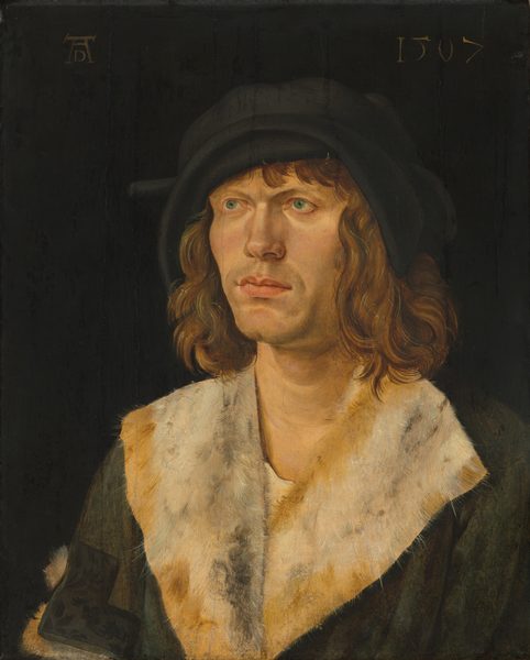 This painting is a portrait of a man from the chest upwards, his body and head turned slightly to the left. The man has pale skin, blue eyes, high cheekbones, slightly furrowed brows, a straight nose, and pink lips in a neutral expression. He has shoulder-length wavy brown hair and wears a dark green jacket with a white-and-yellow fur collar and a floppy black hat with a brim that curves around his forehead. The background is plain black. A monogram is visible in the top left corner, and the date "1507" is inscribed in the top right corner.