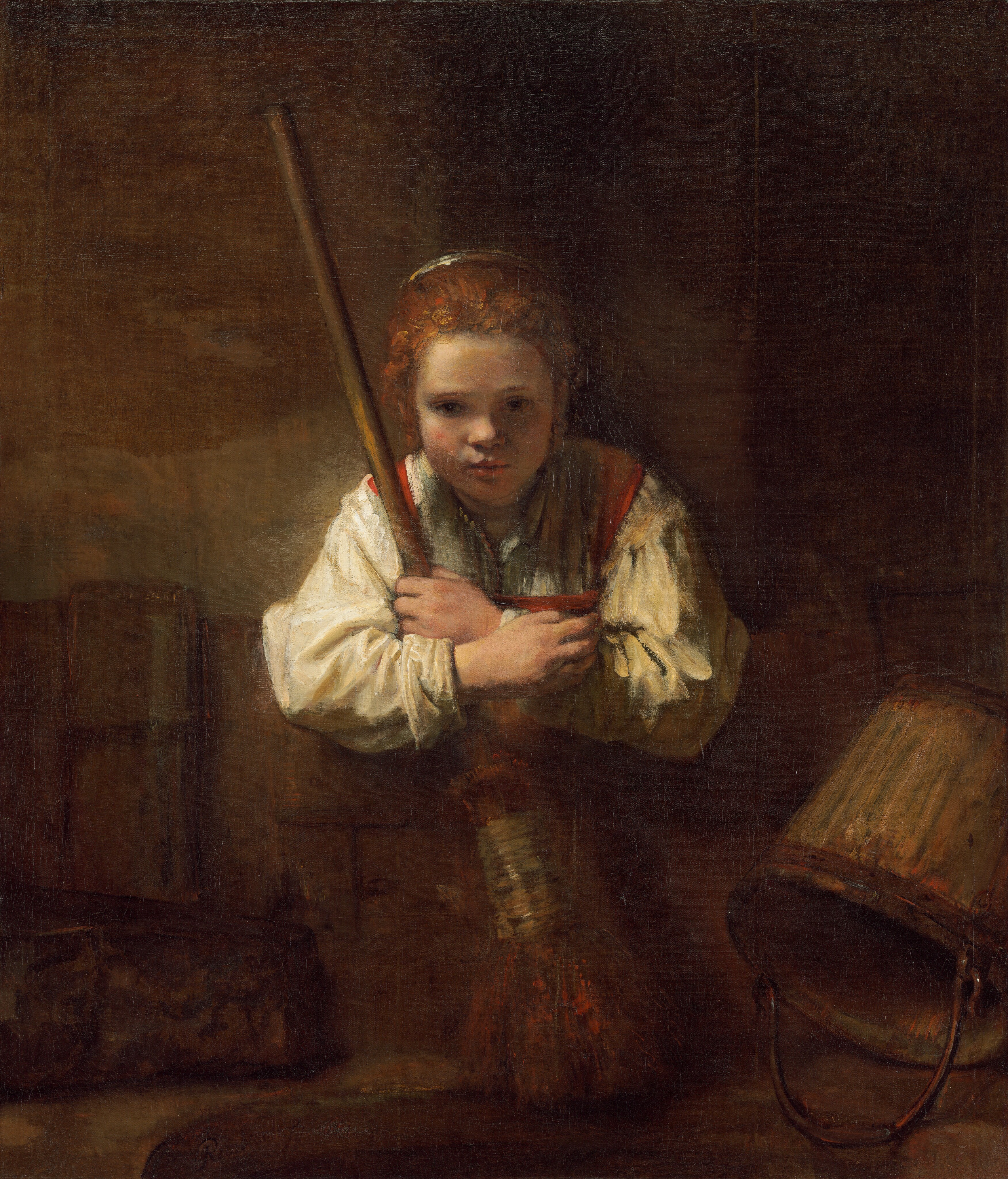 A pale-skinned young girl leaning over a low fence and holding a broom gazes in our direction in this vertical painting. Her red hair is pulled back from her round face, and she has large hazel eyes under thin brows, a petite nose, and her coral-red mouth is slightly open. She is shown from the chest up, behind a wooden partition that spans the width of the painting. She wears a loose, ivory-white shirt under a garment with pumpkin-orange straps on the shoulders and chest. She leans forward with her elbows hooked over the partition as she holds a long-handled broom to her chest. A wooden pail with a bronze handle is overturned to the right of the broom. A blocky brown object to our left is difficult to make out. A dark brown semicircular object close to us in the center of the composition resembles the mouth of a well. Soft light from the upper left illuminates the girl and the left side of the caramel-brown wall behind her and throws the right side into shadow. A signature near the lower left looks like it had been painted on the inner edge of the well. It reads, “Rembrandt f. 1651.”