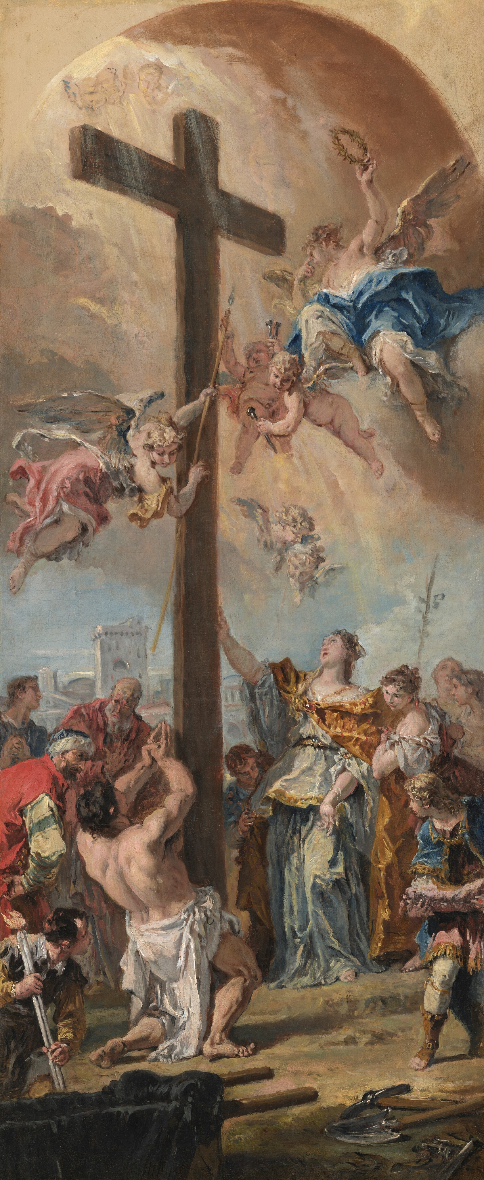 This is a painting of a scene with a large cross at the center. The painting depicts a gathering around the cross, with angelic figures flying above amidst clouds. Some of these angels hold instruments, garlands, or tall staffs. On the ground, a group of individuals in colorful attire surround the bottom of the cross with a backdrop of a classical cityscape, including arches and stone buildings. In the bottom left, a man wearing a white cloth on his waist kneels down in front of the cross, his hands raised in prayer. To the right, two women in flowing clothes of gold and seafoam-green look at the cross, one resting her hand on it. At the very top of the painting, above the cross, is a pale-yellow arch.