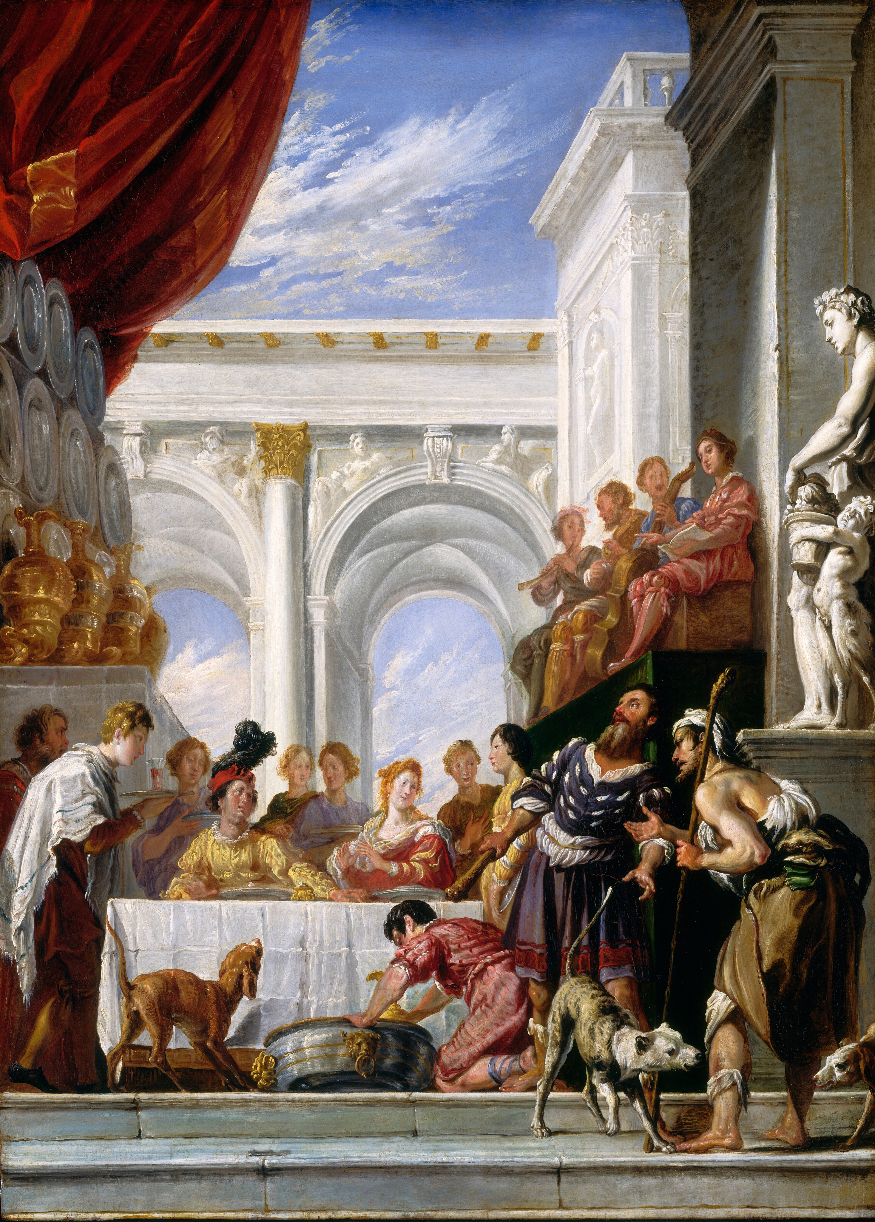 Sixteen men and women sit, stand, or play music at or around a table surrounded by white marble buildings in this vertical painting. All the people have pale skin, and most have round faces with small features and wear dresses or robes in canary yellow, rose pink, lavender purple, moss green, topaz blue, or golden brown. Two stone steps along the bottom of the composition lead up to the table, which is covered with a white cloth. Three people are on our side of the table and the rest are next to or on the other side of it. A young, clean-shaven man brings a glass filled with red liquid on a tray at the left end of the table. Two people sit at the table set with two silver platters and a gold, fist-sized vessel. To our left, the man leans away from the woman and looks up and to our right, toward the musicians who sit and play on a raised platform. The man at the table wears a red hat with a billowing black feather, and his brows are gathered. To our right, the woman holds her hands up in front of her chest, palms facing each other. She looks to our right at a pair of men standing on our side of the table in the bottom right quadrant of the composition. Those two men have darker toned, peachy-colored skin, long beards, straight, pointed noses, and angular features. Both look off to the left. In this pair, the man to our left holds a club in one hand and leans back. He wears a royal-blue jerkin, a muted purple, knee-length toga, and shin-high, toeless sandals over bare, muscular legs. Decorative slits are cut into his jerkin so puffs of the white linen shirt he wears underneath can be pulled through. To our right in this pair, the other man faces our left in profile. He leans heavily against a tall staff and wears tattered white and earthy-brown clothing. A white cloth is tied around his scraggly hair and another around a wound on one shin. Two dogs growl at each other at this man’s bare feet. The third person on our side of the table kneels next to a tub-sized, silver and gold wine cooler, which holds a gold urn. A dog next to the cooler crouches and growls at the table or musicians, the tail erect and ears back. The musicians sit on a shallow platform to the right. The platform is as high as the people standing in front of it, and it is covered with a forest-green cloth. The musicians play instruments resembling a horn, violin, and cello, and the fourth holds an open book and lifts one finger, conducting. A similar platform across from them, to the left of the table, is covered with a white cloth and holds a display of oversized gold urns and silver platters. White arches carved with statues and decorations rise behind the table and frame a view of thin clouds across a vivid blue sky. The sky also fills much of the top quarter of the composition, and a scarlet-red curtain has been pulled to the left and tucked behind the silver dishes.