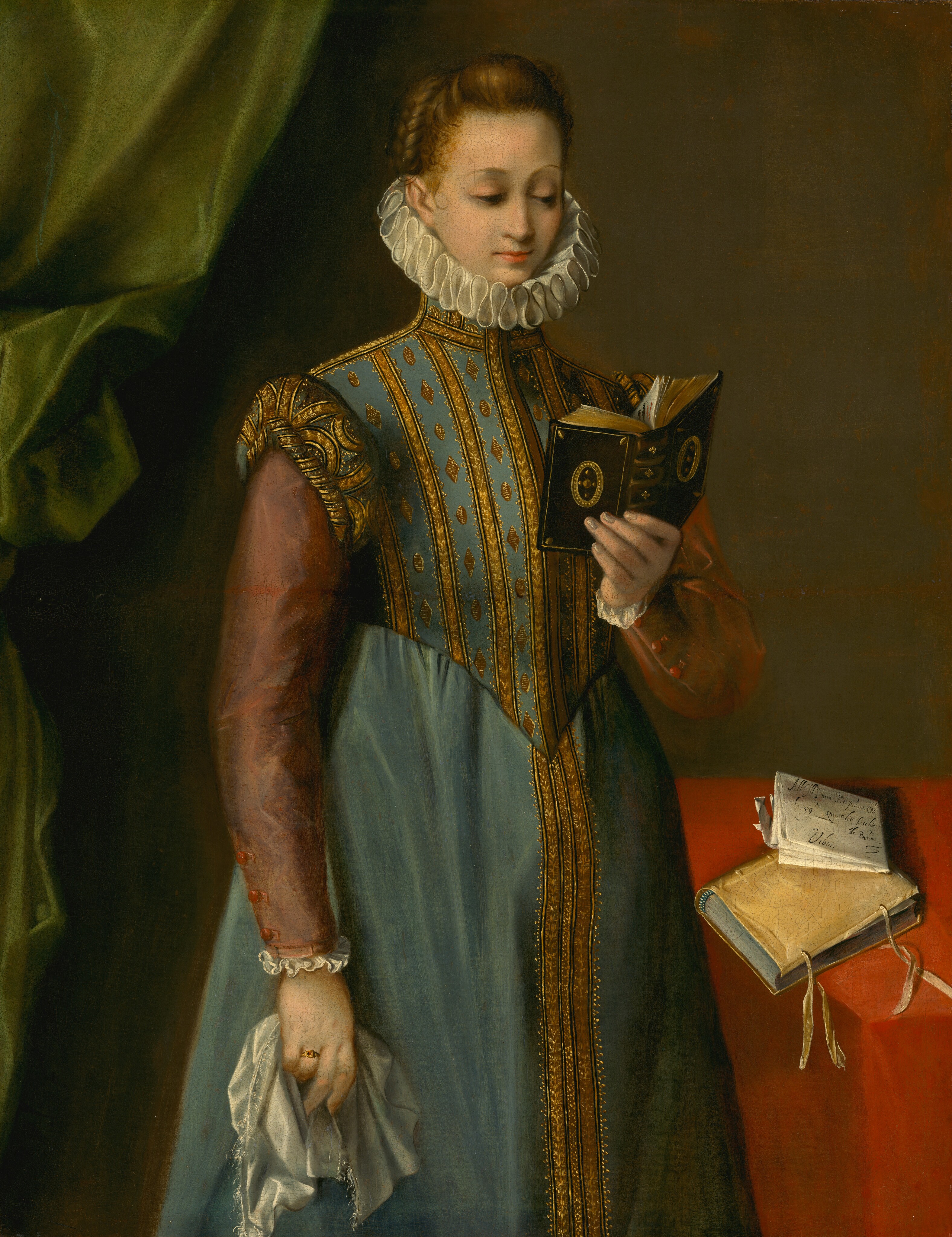 Shown from about the knees up, a woman with pale skin and honey-brown hair stands in the center of this vertical portrait painting. She turns her body slightly to our right and looks down to read a small, chocolate-brown book held up in her left hand, to our right. The book is decorated with gold bands and medallions on the spine and both covers. Her eyes are hooded under faint brows. She has a straight nose, and her small, coral-pink lips are closed. Her hair is pulled back and braided up along the side of her head. Small, translucent tendrils curl over her right temple, to our left. She wears a long, topaz-blue gown with gold trim down the high-necked bodice and the front of the skirt. The dress has dusty rose-pink sleeves edged with white ruffles at the cuffs. A white collar, pleated into figure-eights, nestles around her chin and the base of her skull. Her right arm, to our left, hangs by her side and she grasps a silvery white handkerchief bordered with thin fringe. She wears a gold ring with a red stone in a square setting on the third finger of that hand. A table covered in a scarlet-red tablecloth angles toward us to our right. Almost falling off the edge is a second book in a parchment-gold binding. The two ties at the edges of the pages are loose, and a sheet of folded paper sits on top of the book. Black script on the paper reads, “All'Ill re mia s rae p rona Oss ma la sig ra quinti lia fischieri de Bon a Urbino.” A fern-green curtain is bunched along the left side of the painting, and the rest of the background is olive green.