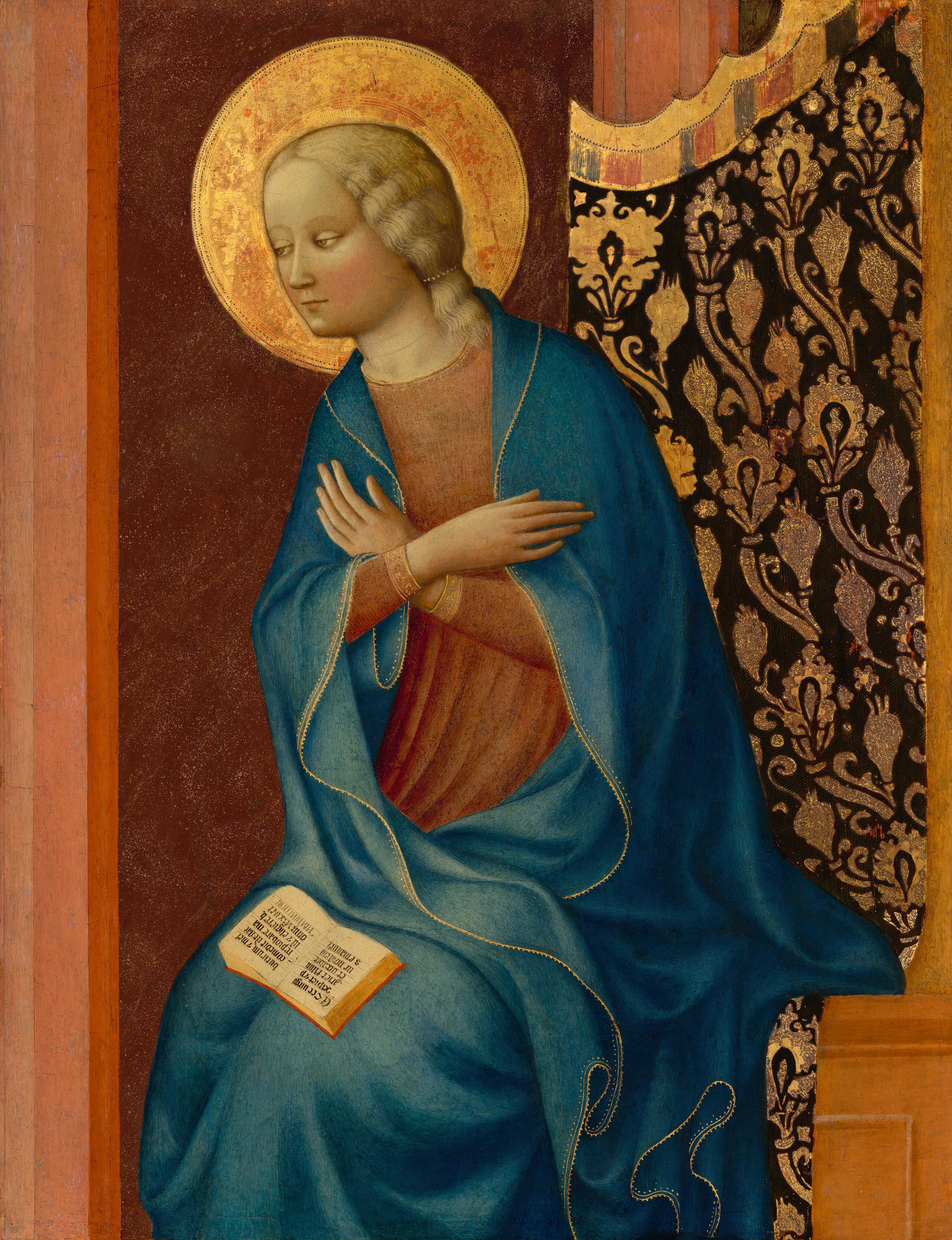 This painting shows a woman seated with her hands crossed over her chest. The woman is turned toward the left, and she has pale skin, rosy cheeks, a small mouth, light eyes, and shoulder-length blond hair. She is wearing a blue robe with gold edges over a long-sleeved red tunic. A golden halo surrounds her head, and an open book rests on her lap. The background is mostly dark red with some vertical lines in lighter shades of red. On the right is a dark fabric curtain with gold embellishments. The bench the woman sits on is light brown.