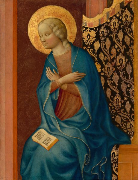 This painting shows a woman seated with her hands crossed over her chest. The woman is turned toward the left, and she has pale skin, rosy cheeks, a small mouth, light eyes, and shoulder-length blond hair. She is wearing a blue robe with gold edges over a long-sleeved red tunic. A golden halo surrounds her head, and an open book rests on her lap. The background is mostly dark red with some vertical lines in lighter shades of red. On the right is a dark fabric curtain with gold embellishments. The bench the woman sits on is light brown.