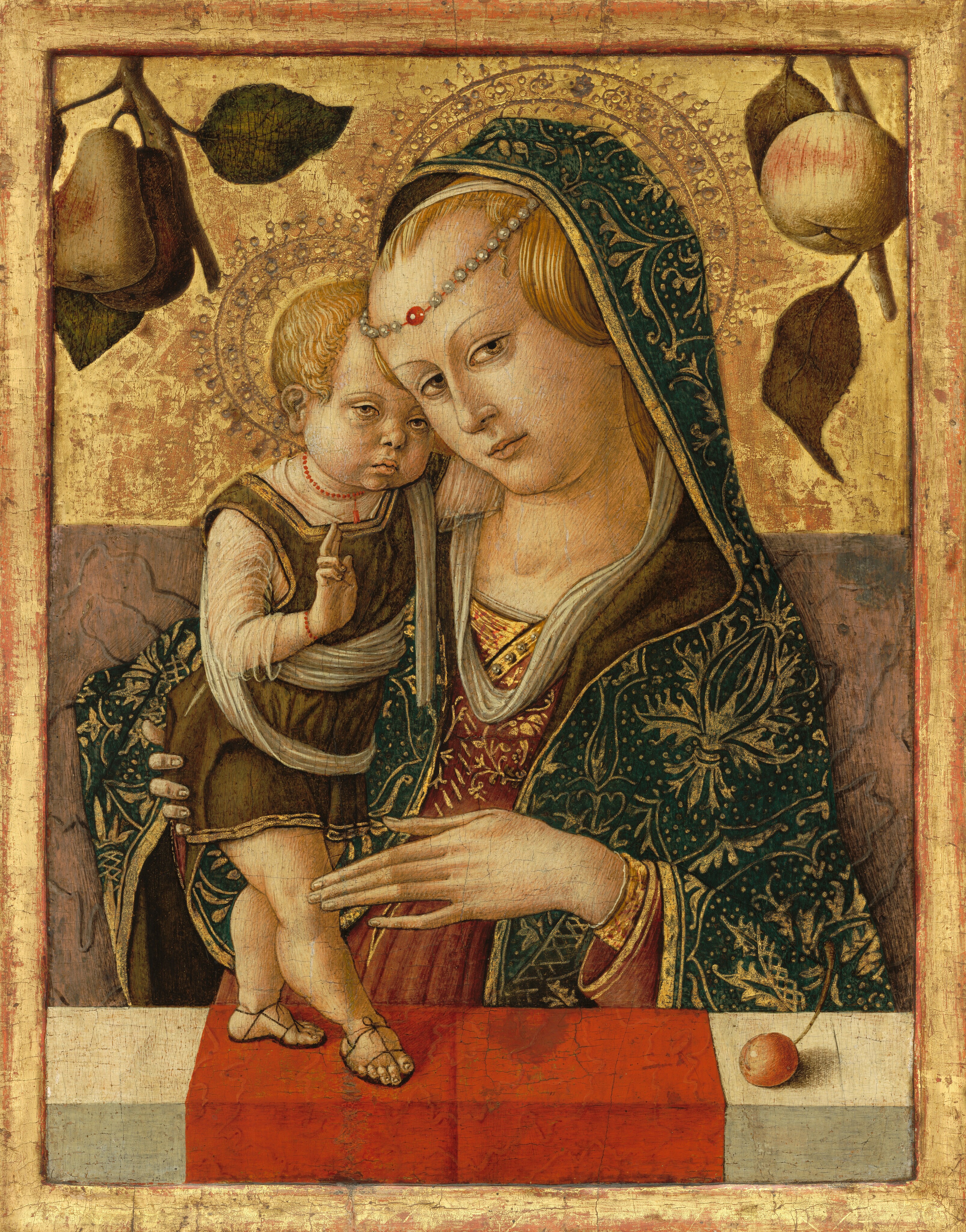 A woman is shown from the waist up behind a ledge, on which a baby stands in front of a gold background in this vertical painting. Both people have pale skin, blond hair, light brown eyes, and small, pale pink lips. To the right, the woman’s body is angled slightly to our left, toward the child. Her head tips down so her forehead overlaps the baby’s head. The woman has close-set, almond-shaped eyes under thin brows. Her hair is pulled back and her head encircled with a string of pearls and a red bead or gem, which rests in the middle of her forehead. Her hair is also partially covered by a white veil and a blue cloak patterned with gold leaves, vines, and dots. The lining of the cloak is moss green, and her dusky pink dress is also edged and decorated with gold designs. She holds one long-fingered hand up to the child’s knee and braces his back side with her other hand. The child stands on chubby legs on tiny, sandaled feet. He leans close to the woman and looks off to our right with hooded, wide-set eyes. His lips are downturned, and he has chubby cheeks and a knobby chin. He wears a strand of red beads and a moss-green tunic over translucent white cloth. He stands on a red cloth draped over the center of the white ledge. A piece of a small, round red fruit with a long stem sits on the ledge to the right. The space behind the people’s shoulders is painted muted mauve pink with gray streaks. The woman and child both have halos punched into the gold background above. A branch with two pears is in the top left corner and another branch, perhaps holding an apple, is in the top right. The panel is framed by a raised lip, also painted gold.