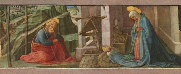 A woman kneels in front of a baby under a stone structure to the right as a man sits and dozes in front of a landscape to the left in this wide, horizontal painting. All three people have pale, peachy skin with rosy cheeks and gold, flat, disk-like halos. To our right, the woman’s head and shoulders are covered with a white cloth as she crosses her hands across her chest. She wears a rose-pink dress under a voluminous, sky-blue robe lined with spruce green. The robe puddles on the floor behind her feet, and one section has been pulled forward to be used as a blanket for the baby. The child has blond hair and round cheeks, and is swaddled in white under the robe. He is propped up against stacked rolls of hay. A room-like space with pale pink stone walls stretches back beyond the woman. The wall to the left is pierced with an arched opening. A trough lines that wall on the woman’s side of the opening, and another is perpendicular to it, just beyond the baby. An ox pokes its head through the opening, and an ass looks across the second trough. To our left, the man sits with at least one knee pulled up. He has long blond hair, a white beard, and wears a sapphire-blue tunic and red robe. He leans one elbow on his bent knee and rests his head in that hand, his eyes closed. A staff with a sack tied to the end rests against his other shoulder. He sits on a flat, green area at the foot of sheer-cut, green, rocky hills. More hills, trees, and a path lead back into the distance to towns along the horizon. The upper and lower edges of the panel are painted with pale pink similar to the building, making it seem that we look through a partial frame at the scene.