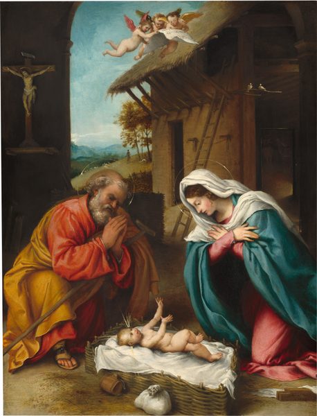A young woman and an older man kneel to either side of a nude baby outside of a barn-like structure in this vertical painting. The people and three winged angels overhead all have pale skin except the older man, who has a more tan complexion. To our right, the woman kneels with her hands crossed over her chest, facing our left in profile. She looks down with dark eyes, and has a long, straight nose, flushed cheeks, and pink lips. Her wavy, chestnut-brown hair is mostly covered by a voluminous white veil that drapes across her shoulders. She wears an azure-blue cloak over a rose-pink, long-sleeved dress, which puddles under her knees. To our left, the man kneels with his hands held up near his face in prayer. He has dark eyes and a short, stubby nose. He is balding with a fringe of curly gray hair, and he has a full, graying beard. He wears a coral-red robe wrapped in a mustard-yellow cloak. The edges of white cuffs are visible at his wrists. One sandaled foot peeks out from under his robe as he kneels on the other knee. A walking stick lies across one arm, braced in his lap. Glimmering gold rings create halos around the man and woman's heads. Between them and on a white cloth in a woven basket, the baby has a pudgy face and body as he lifts his hands toward the woman. One foot is also raised, chubby knee bent. The infant has dark eyes and blond curly hair. Clusters of three lines emanate from the top of his head and to the sides over each ear. A wooden container and a white sack sit on the dirt ground, next to the basket. Beyond the group is a wooden structure with a thatched, overhanging roof. Two white birds sit along a branch tucked in the supports holding up the roof, and a ladder leans against the side of the barn. A crucifux hangs from a deeply shadowed wall behind the man, along the left edge of the painting. Three, winged, childlike angels gather around a piece of sheet music at the top center of the painting. They all have dark blond hair but different colored wings, in coral pink, forest green, or golden yellow. Below, trees and grassy hills lead back to hazy blue mountains along the horizon in the deep distance. A person and white sheep dot the hillside near the structure. The sky above deepens from ice blue at the horizon to aquamarine blue across the top edge. The artist signed and dated the painting as if he had inscribed a plank of wood near the lower right corner: “L. Lotus 1523.”