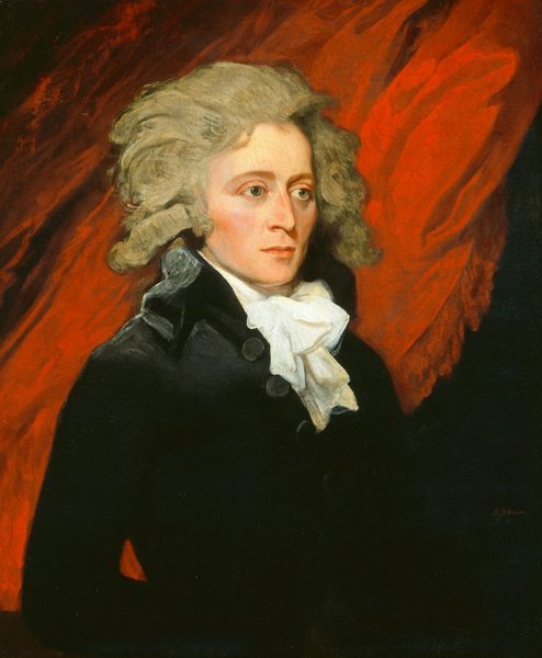 The image shows a portrait of a person from the upper half of their body. They are facing forward but their head is turned slightly to the side, suggesting a profile view. The person has sharp facial features, light-colored hair styled in a classic manner, and is wearing a black coat with a high collar and a white cravat. The background consists of a red drapery.