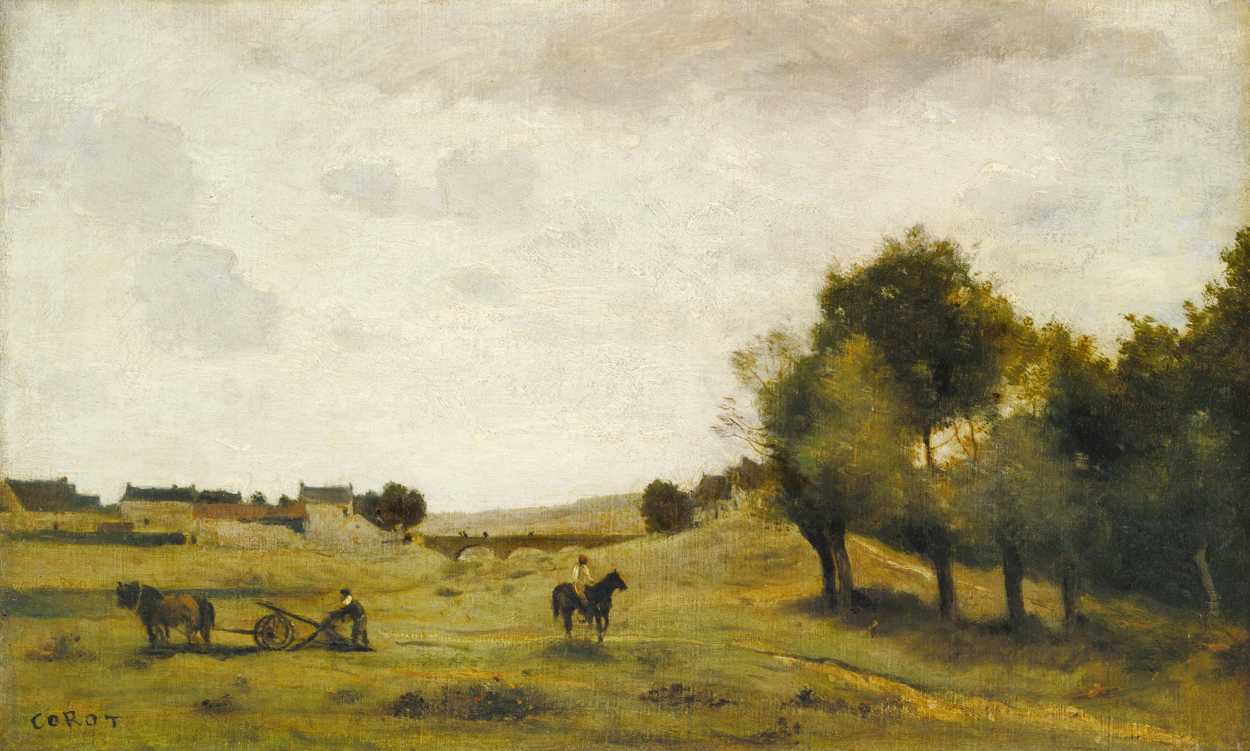 A person at the center of this loosely painted horizontal landscape rides a dark horse across a field as a man to the left works the field behind a horse-drawn plow. The field is carpeted with muted and gold-shaded green, and a grove of trees in the right third of the composition are painted in fern, olive, and dark green. A patch of darker green near us and to left of center is dotted with red and yellow to suggest flowers. The men and horses are small in relation to the composition. The people have brown skin and are painted with a few strokes in dark gray and muted green for the man behind the plow to the left and pale yellow and white and a red cap for the person on horseback. A band of houses with tan or light yellow walls and gray or terracotta red roofs line the far side of the field to the left, and an arched bridge crosses what appears to be a shallow, grassy ravine near the center. The horizon comes about a third of the way up this composition and a few smoke-gray clouds line the upper edge of the otherwise milk-white sky. The artist signed the lower left corner, “COROT.”
