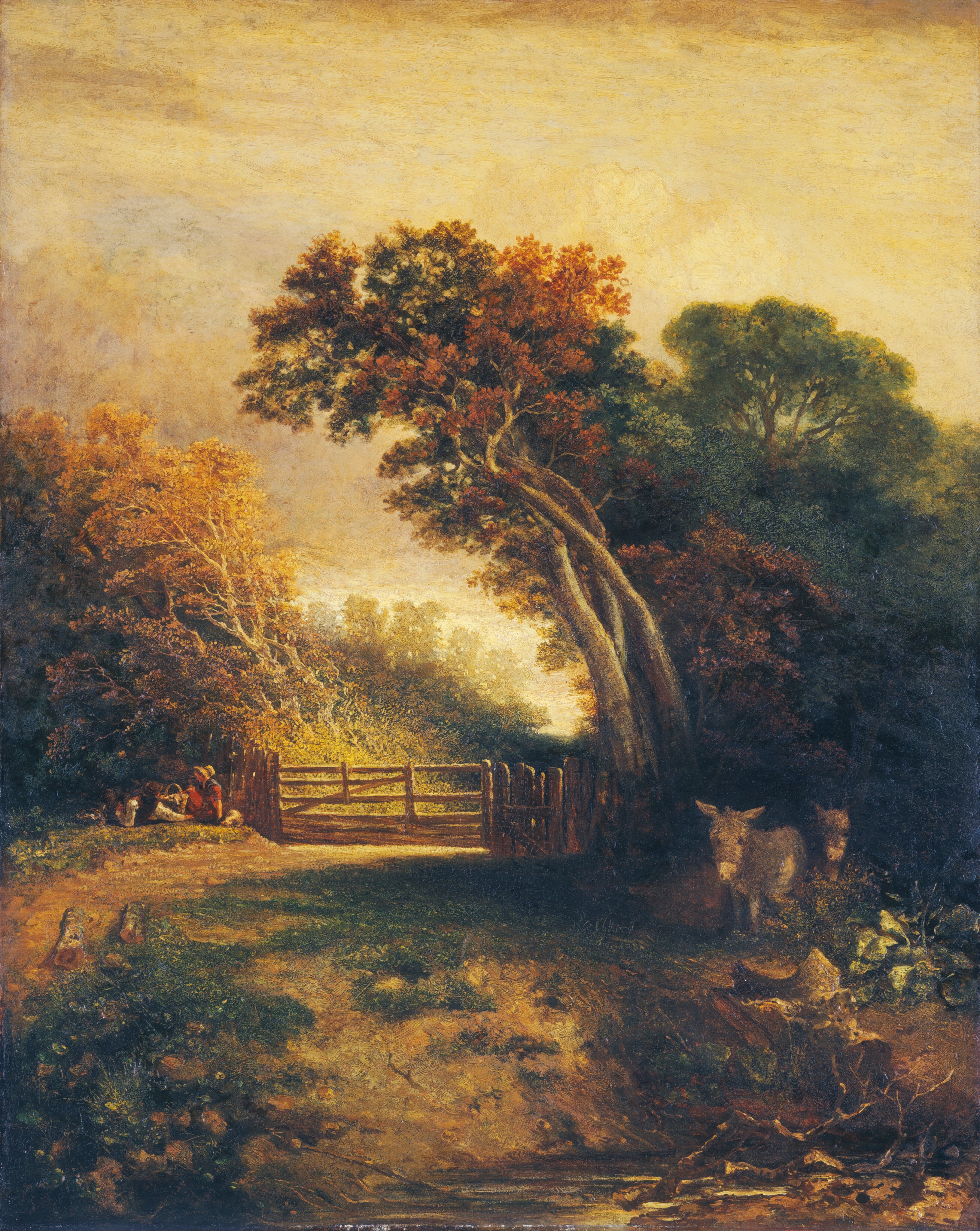 This painting shows a serene pastoral scene with trees, a wooden gate, and foliage extending towards the horizon. Closest to us, there is a low riverbank with some tree branches in the water. Up a grassy dirt hill, two donkeys are visible off to the right, partially hidden by vegetation. On the left, a dirt path leads to the wooden gate. To the left of the gate, two people sit on the grass with a wicker basket between them. The tall trees that rise in the background have leaves in shades of green, yellow, and dark orange. The sky above the scene is yellow with some hints of light blue, and golden light shines down on the landscape.