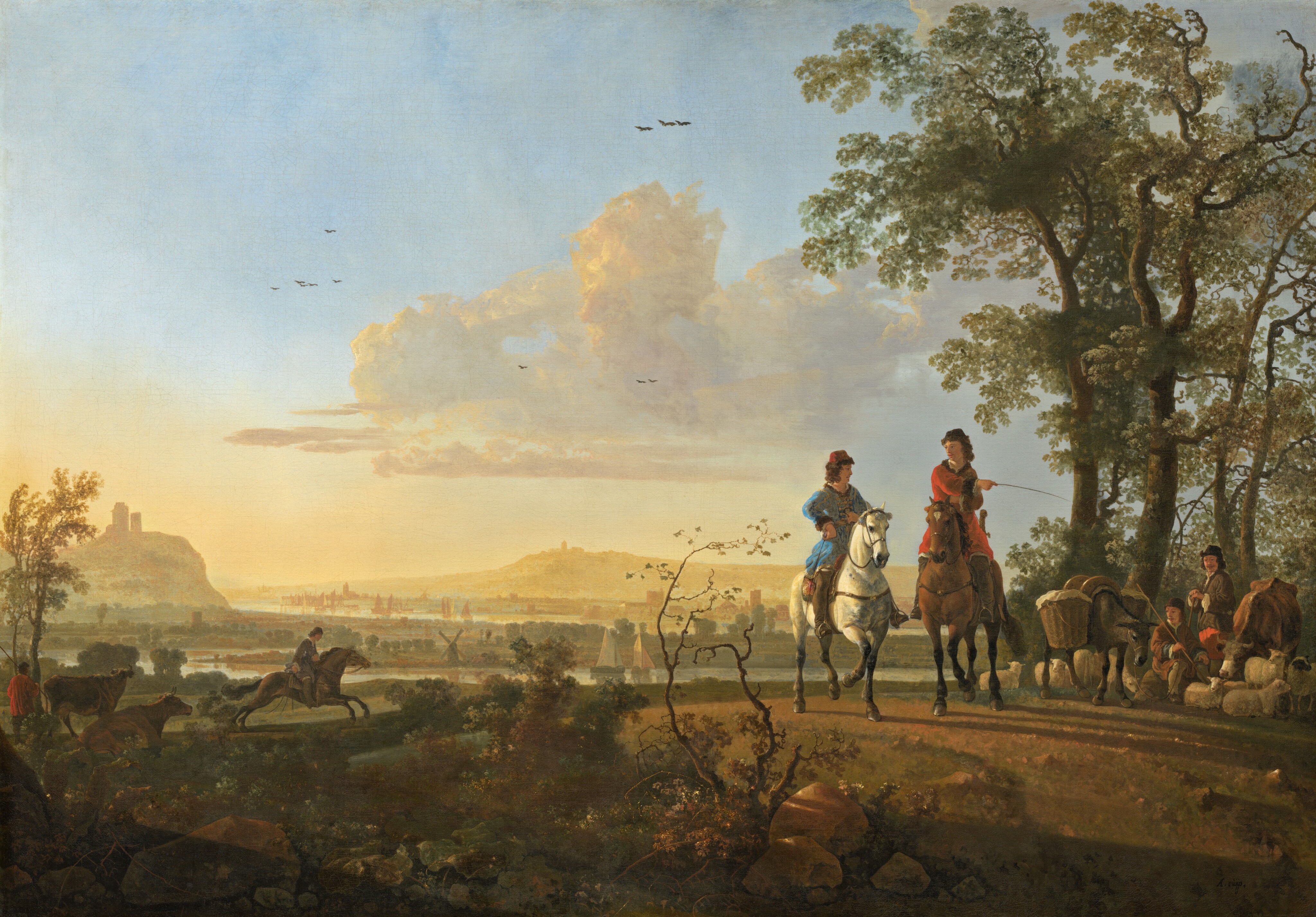 Golden sunlight pours across a landscape with three people on horseback and two more people near a flock of sheep, a cow, and a mule in this horizontal painting. The people all have pale, peachy skin. The horizon is about a third of the way up the composition and is lined with towers on distant, hazy, pale yellow hills. Two of the horses are to the right of center, both facing us. The horse on the left is white, and the rider wears an azure-blue tunic and red brimless cap. The other horse is brown with a white blaze, and its rider wears a red tunic and black cap. That second rider points with a whip to the sitting and standing people near the sheep, to the right. Those two people wear brown jackets, and the standing man has a mustache. The seated person rests a long staff over one shoulder. About half of the nine sheep there lie on the ground, and the others stand. The cow dips her head down to the sheep, and the splay-footed donkey has baskets hung to each side. This grouping is in front of a copse of tall trees that nearly reach the top edge of the composition. The third rider is to our left and a short distance away. That dark brown horse gallops to our right. A short distance away, another herdsman along the left edge of the composition wears a red tunic and brown pants, and he rests a long staff on one shoulder. One cow stands and one lies down next to that herdsman. Sunlight rakes across twigs, leafy plants, scrubby growth, and rocks in the foreground, closest to us. Sailboats float on the waterways that stretch horizontally across the painting in the distance, and the land separating those bodies of water is dotted with spires, windmills, towers, and other structures. A dozen dark birds fly high in the sky, which takes up the top two-thirds of the picture. A bank of iridescent yellow and pearly white clouds trundle across the pale blue sky. The artist signed the painting in the lower right corner, “A.cuijp.”