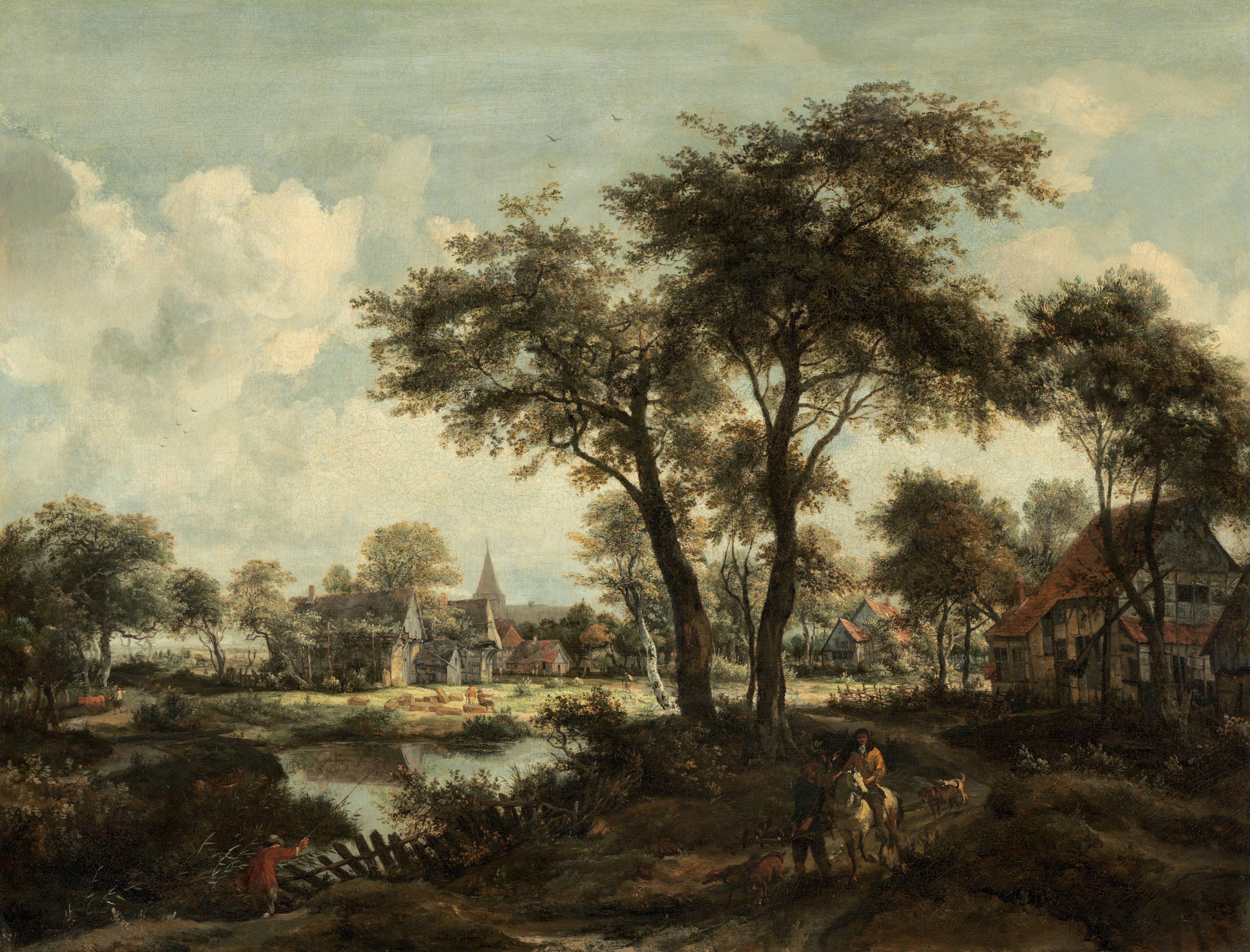 This painting shows a landscape with several buildings near a body of water. Closest to us, near the bottom right corner, a person in red leans over a wooden fence to cast a fishing rod into the water. The fence is surrounded by tall grass and bushes with small pink flowers. On the right, a path leads up towards the buildings. Two people and several dogs walk along the path towards us and away from the buildings, emerging from some tall dark trees. One person rides a white horse, while the other appears to hold a stick with several birds sitting on it, and offers a bird up to the rider. These people are in shadow and their details are hard to discern. Beyond them, the path curves by two large, white buildings with pointed red roofs. As the path curves to the left in the distance, it passes through a grassy plain near the edge of the water. More people can be seen, one walking along the path and two sitting by rocks near the water. The path leads towards a small village to the left of center. The village has more cottages and a church with a steeple in the distance. The sky above the scene is light blue-gray with fluffy white clouds, and the color palette includes dark greens, browns, and grays.