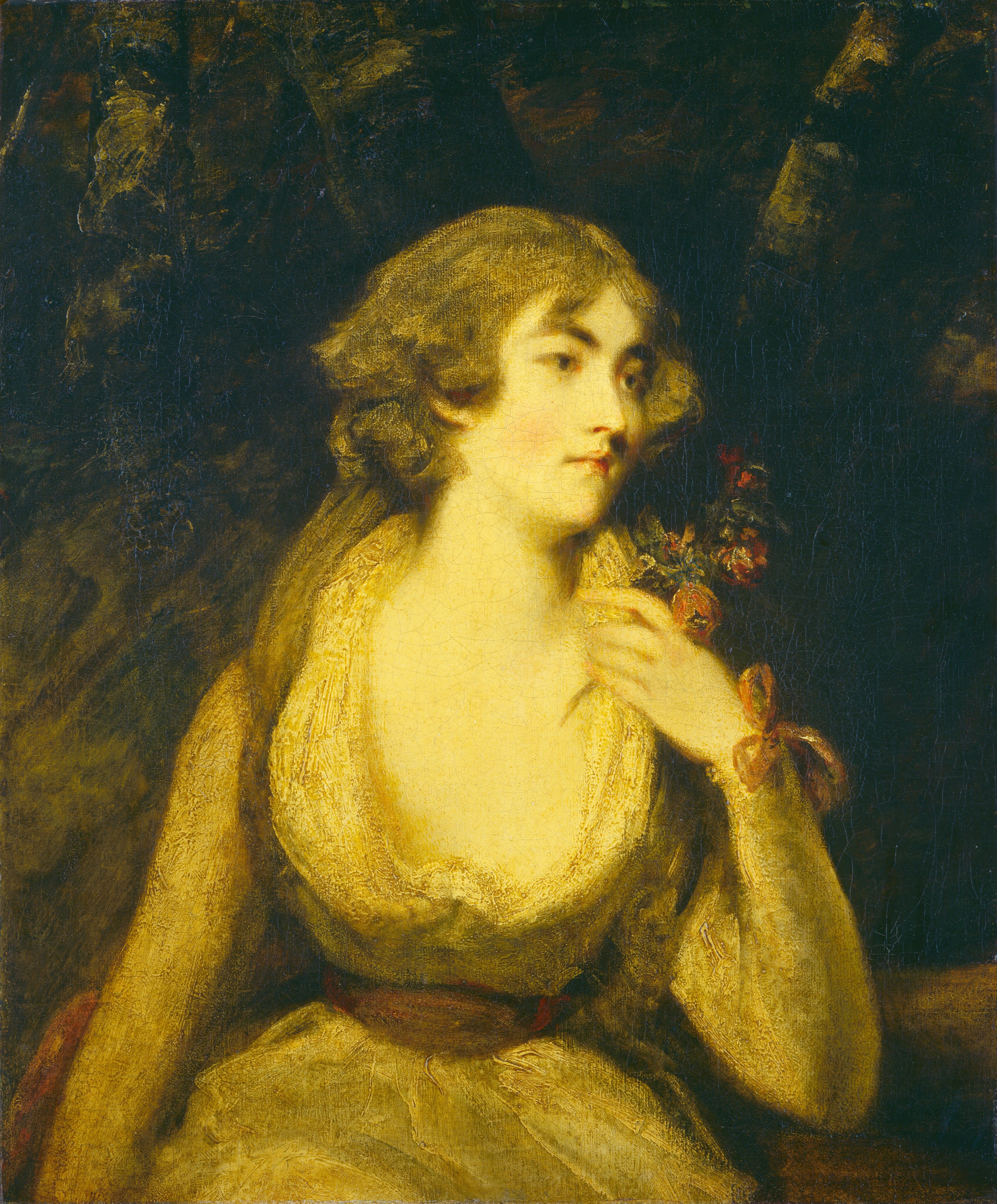 This is a painting of a woman who is depicted from the waist up. She is positioned sitting or leaning with her head turned to the right. She has pale-yellow skin, and her facial features include red lips and dark eyebrows. Her hair is light brown or perhaps gray, styled in loose waves that frame her face. The woman is wearing a yellow dress with a deep neckline adorned with lace, and a brown belt is cinching her waist. She holds a small bunch of flowers with red petals close to her neck, and there is a red ribbon around her wrist. The background is dark and abstract, with hints of greenery or foliage.