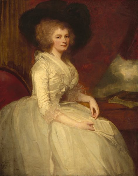 This painting shows a woman seated in a slightly angled position towards the right, her head facing us with what appears to be a small smile. She has pale skin, rosy cheeks, and curly, gray-brown hair styled in voluminous curls, partly covered by a large, dark, broad-brimmed hat. The woman is dressed in a cream-colored gown with ruffled lace details at the neckline and cuffs. Her right arm rests on her lap, holding a folded piece of paper or a letter, while her left arm is placed on a surface to the right. The background has a warm reddish-brown town and appears to include a draped curtain. On the right side, there is a small red surface with more papers or letters, as well as a white-gray section that appears to show a cloudy sky.