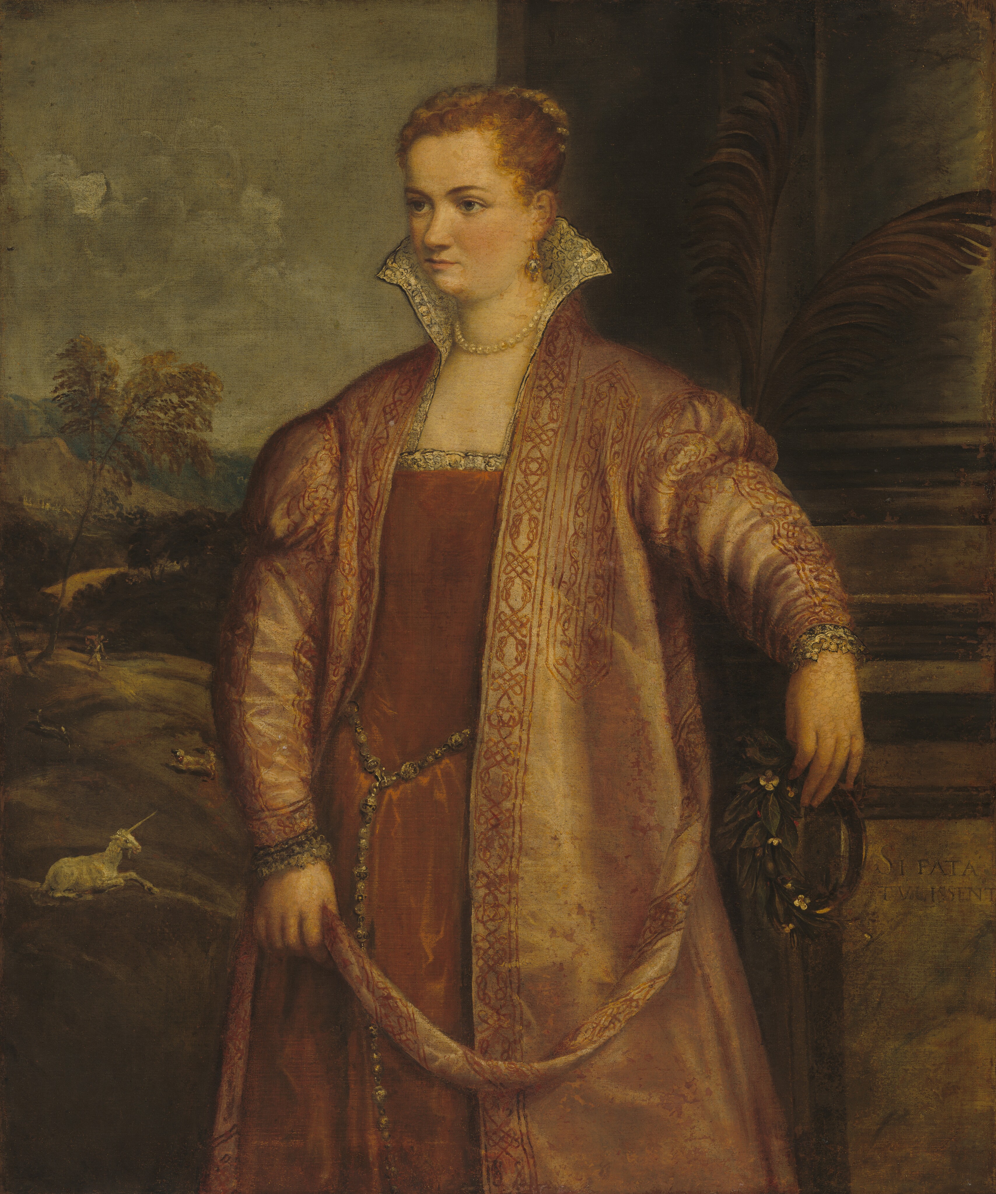 Shown from the knees up, a pale-skinned woman wearing a muted red gown and shimmering coat stands against a stone column in front of a landscape in this vertical portrait painting. Her body angles to our left, and she looks off in that direction with gray eyes under curved brows. She has a round face with a slightly snub nose, flushed cheeks, double chin, and her thin lips are closed. Her strawberry blond hair is pulled back under a band wrapped with pearls. Her copper-red dress has a square neckline lined with lace, and a gold and pearl belt is looped around her waist as a long strand lies down the front of her skirt and off the bottom edge of the canvas. The voluminous coat she wears has a high, flaring collar lined with lace or patterned with black lines against white. The pale, almost iridescent golden-red fabric of the coat has a sheen, suggesting satin or silk, and it is decorated down the front, over the shoulders, and down the sleeves with a geometric design in copper red. The cuffs of the coat are lined with lace, and the woman wears a gold and silver earring in the ear we see and a strand of white pearls around her neck. The woman drapes her left arm, to our right, over the chest-high base of the column, and holds a ring of leaves in that hand. The other hand is by her side as she holds the coat belt to curve like a swag across her body. A pair of palm fronds feather out against the column that fills the right half of the background. A deep landscape on the left half has rolling hills, trees, and mountains reaching back to the horizon under a sky with puffy white clouds. A white unicorn lies on one hill and a dog chases an animal farther back. Beyond that, a person walking along a path back may carry a sack. The tonalities of the whole painting are shaded yellow, and some areas of the woman’s face and neck are in-painted in slightly different shades of pale peach. An inscription carved into the base of the column reads, “SI FATA TVLISSENT.”
