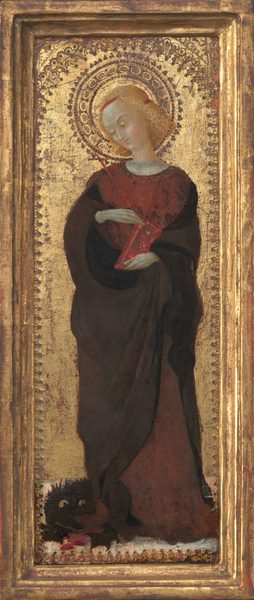 This painting shows a person standing, their body turned to us, with their head looking downward to the left. The person has pale skin, round, rosy cheeks, and wavy yellow hair surrounded by a golden halo with intricate patterns. They are wearing a dark robe over a dark red dress or tunic and holding a long, thin red cross in one hand, while the other hand holds a closed red book. At their feet lies a black dog-like animal with wide yellow eyes. The scene is set against a golden textured background within a gilded border.