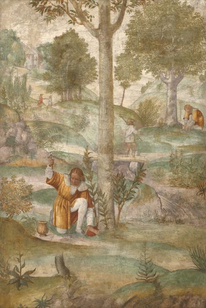 This is a fresco showing a pastoral scene with human activity. The viewpoint is slightly elevated, overlooking a hilly landscape with structures, trees, and five people, some of whom are dressed in gold robes. The people are engaged in various activities such as walking across the hills or kneeling beside a tree, tending to something on the ground. The person closest to us is to the left of center, kneeling down and lifting a small hammer in the air. This person has pale skin and golden hair, and they wear a golden robe over a white shirt and white pants. The color palette is muted and earthy, with soft greens, browns, and yellows dominating the scene.