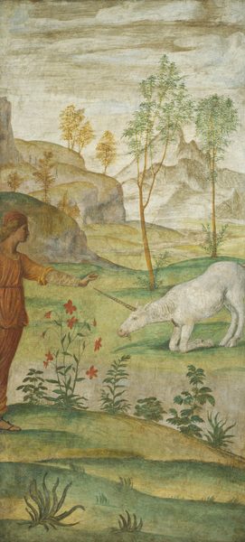 This tall, vertical fresco depicts a person in a red garment extending their arm towards a white unicorn that is bowing down on grass. The person is on the left side of the image, and only partially visible. The unicorn's long horn almost touches the person’s outstretched hand. The unicorn's back legs are extended, but its front legs are kneeling. The person and unicorn are on a light green field with red flowers and small green ferns. Behind them are thin trees in front of distant, rocky mountains. The sky above is beige, blending into the earthy tones of the landscape.
