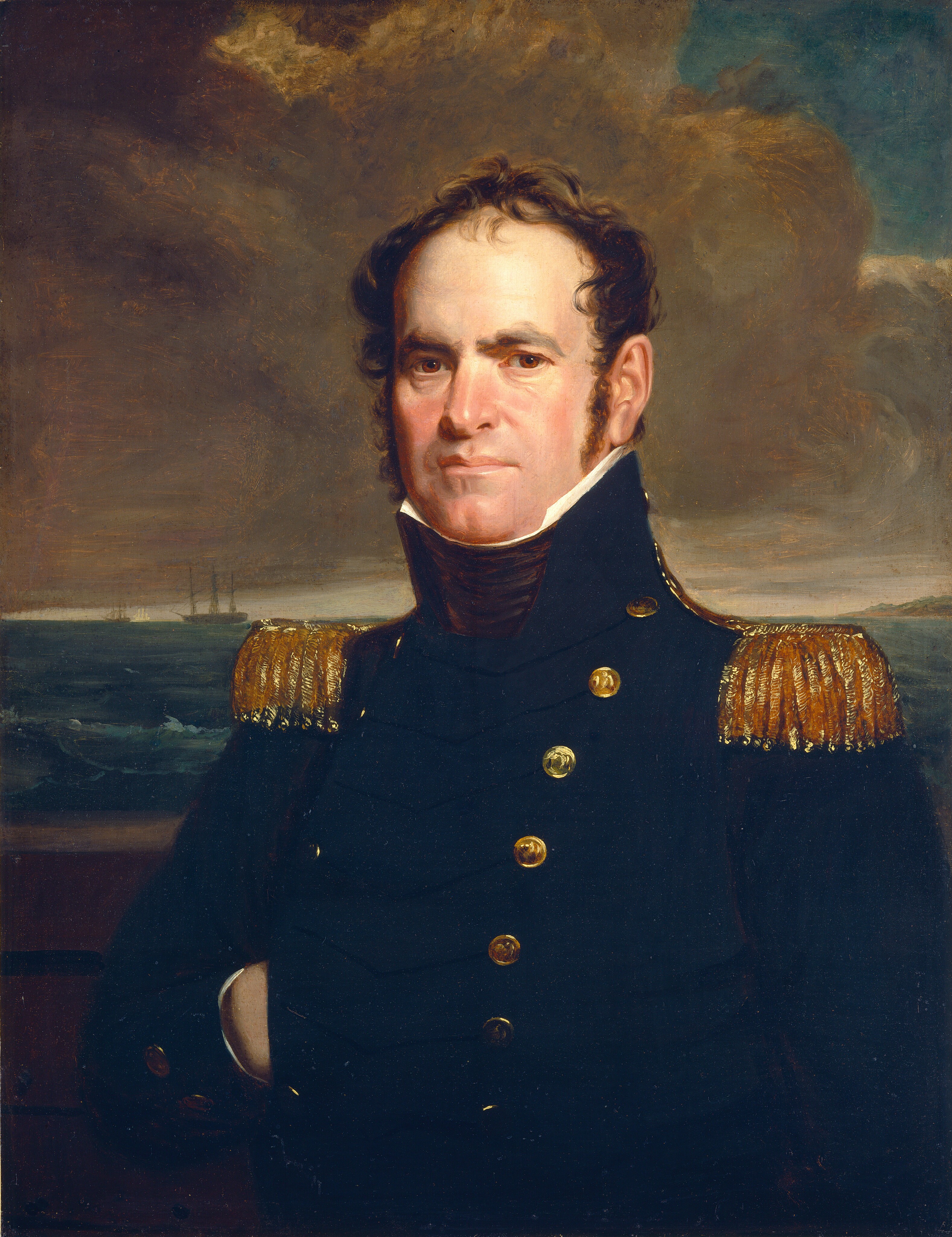 The image shows a portrait of a man from the waist up. The man has a stern expression and a clean-shaven face. He is wearing a navy blue military uniform with gold buttons and epaulettes. His right arm is resting inside his coat. The background features a cloudy sky over water, with a distant ship visible near the horizon.