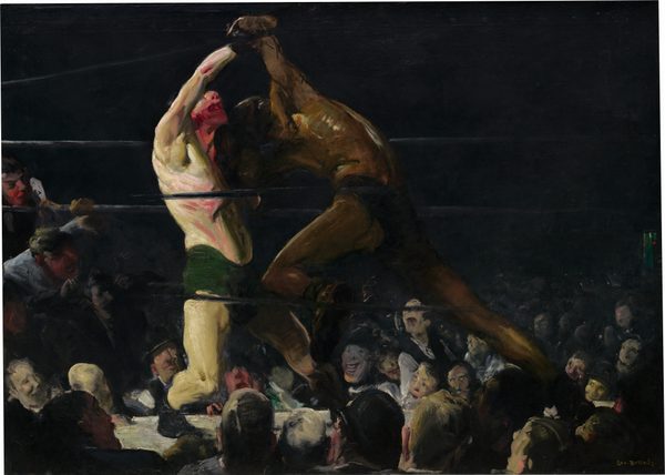 From a darkened arena around a boxing ring, we look up at two bare chested men, one with pale, white skin and the other with brown skin, who lock arms in a boxing match in this horizontal painting. The brushstrokes are loose and visible throughout, making some details difficult to make out. The boxer to our left wears drooping, forest-green trunks and black shoes. He leans back on his bent right leg, closer to us, and tilts his face up. His mouth gapes open and his nose, chin, and neck are smeared with scarlet red, suggesting blood. His pale skin has a green cast, and his chest, arms, and legs are sinewy and muscular. His right arm is raised or pulled up overhead by the boxer to our right. Wearing dark briefs, the second boxer hunches over with head lowered toward the other man’s shoulder. He surges forward onto his deeply bent left knee, closer to us, pushing powerfully off his back leg. His face is lost in shadow and his body has less detail than his opponent, though light glints off his arching back to create gold highlights against his brown skin along his spine, ribs, and muscles of the shoulder. The men’s bodies nearly span the height of the canvas. The black ropes of the boxing ring pass in front of and behind the boxers, and the space around the ring in the top half of the painting is nearly black. Heads and faces of the spectators in the first few rows are lit by the main event and are crowded into the bottom third of the painting. Two spectators on our far left have climbed up and lean on and through the ropes, their mouths open. The crowd, which appears to be all light-skinned men and boys, are painted loosely but their mouths widen in toothy grins or are agape. The artist signed the work in yellow letters against black in the lower right corner: “Geo Bellows.”
