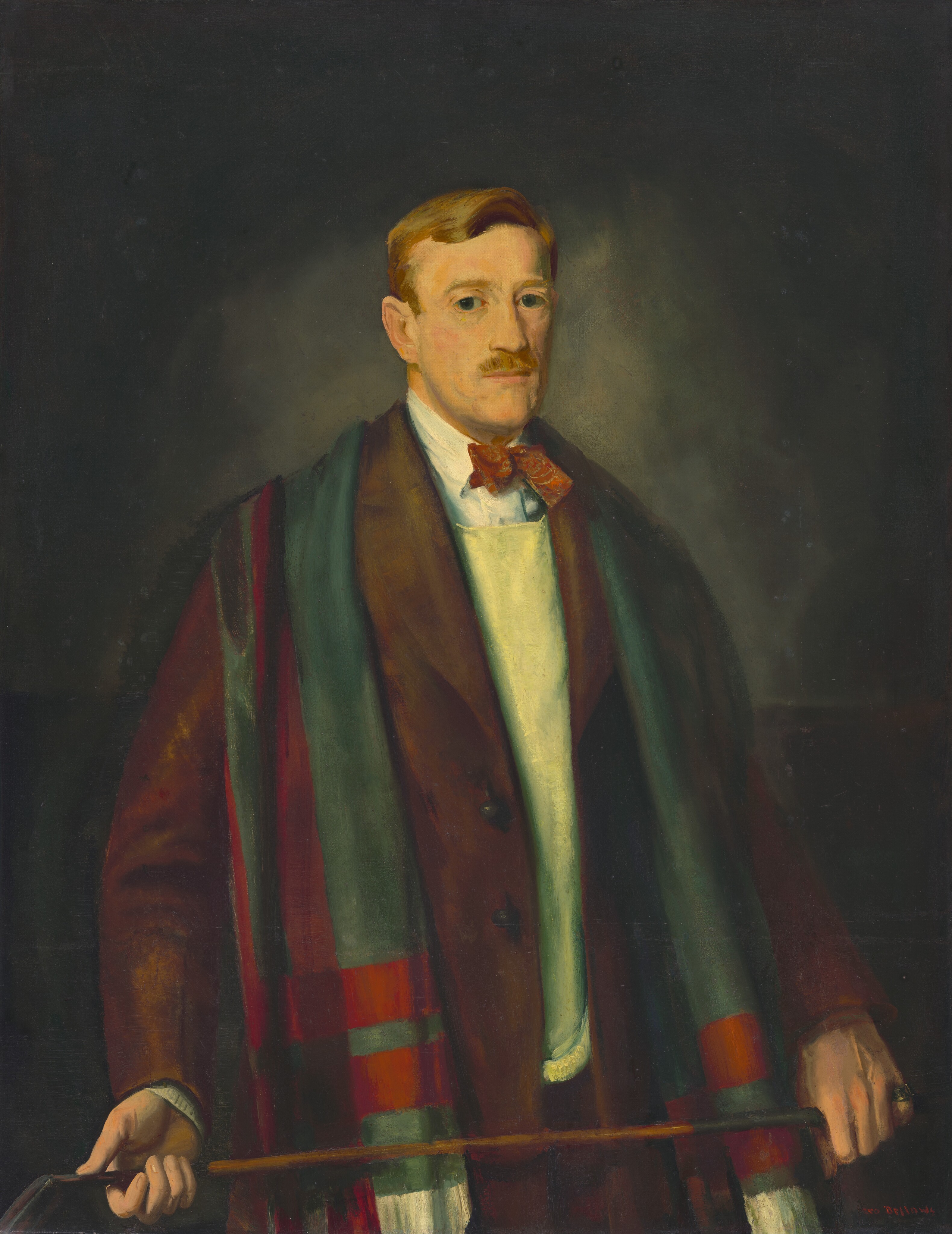 This painting shows a man from the waist up, his body turned slightly to the right. He stands upright, looking at the viewer, holding a golf club or cane horizontally with both hands. The man has a neutral facial expression and a light complexion, a blond mustache, and neatly combed blond hair. He wears a white shirt under a pale yellow sweater and a brown coat, along with a red bow tie. He also has a long, multi-colored scarf draped over his shoulders with red and green stripes visible. The background is gray and becomes slightly lighter around the man's head and darker around the edges.