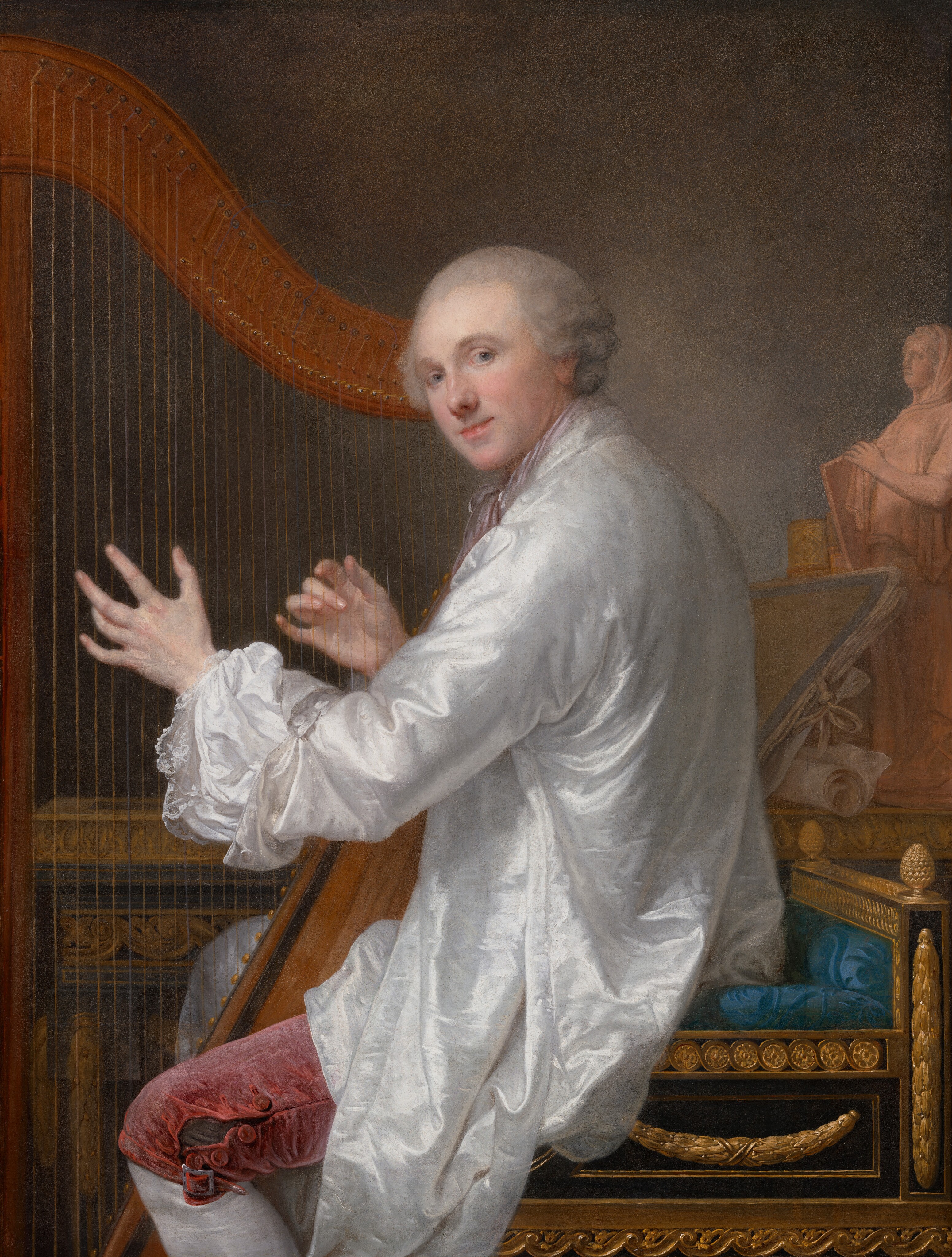 A pale-skinned man sits facing our left as he plays a harp while turning his face to smile at us in this vertical portrait painting. He looks out the corners of his light blue eyes under arched, gray brows. He has a rounded nose, pale pink lips, and a round face. Gray hair is brushed back from his high forehead and curls around his ears. His long fingers rest on the strings of the harp, and the ends of strings curl like wind-loosened strands of hair along the top edge. The man wears a pale mauve-purple cravat, and his snow-white, long-sleeved chemise is untucked and loose around his thighs. The cuff we see is open and folded back over a bright white shirt edged with lace. His dusky rose-pink breeches are unbuttoned at the knee over white stockings. The square-seated chair on which he sits is carved with garlands and floral patterns, which are gilded gold. The seat itself is topaz blue, and it has a low back. A similarly ornamented and gilded table along the back of the room holds a portfolio and roll of papers, the tooled and gilded spines of books, and a statuette to the right. The pale pinkish-orange statuette shows a woman holding a tablet and wearing a long, loose robe and head covering. Her body angles to our left and she looks off in that direction. The wall behind the table is mottled with smoky shades of gray and tan.