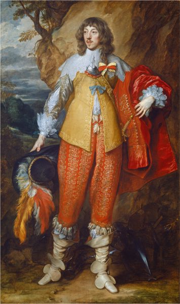 A man with pale skin, wearing a gold-embroidered amber-yellow jacket and tomato-red pants, stands in front of a rocky outcropping with a distant view beyond in this vertical portrait painting. At the center of the composition and taking up most of it, the man stands with his body facing us, but he turns his head slightly to our left and looks off in that direction with slate-blue eyes under curving brows. His smooth cheeks are lightly flushed in his oval face. His full pink lips are closed and are framed by a mustache and small, pointed goatee under his lower lip. His wavy brown hair falls in bangs across his forehead and down to his shoulders. One longer lock has been braided and tied with a yellow and red bow, which rests on the front of his left shoulder, to our right. A wide, lace collar extends from his neck to drape over his shoulders, overlapping a piece of metal armor around the neck, called a gorget. His yellow jacket, a doublet, is embroidered with gold along the hems and where it hangs open down the front to show a white shirt beneath. The silver sleeve we can see is cut with a long slit along the forearm to also show the white linen beneath, and both cuffs have layers of lace at the wrists. A crimson-red coat or cape hangs over his left arm, on our right. His red pants are covered all over with gold stitching above ivory-white, calf-high boots. He holds a wide-brimmed, black hat adorned with plumes of red, white, and marigold-orange feathers in his right hand, on our left. An armored breastplate rests at his feet. He stands on a dirt ground with a tall boulder immediately behind him to our right. The landscape in the distance to our left has a sky filled with steel-gray clouds above trees and hills.