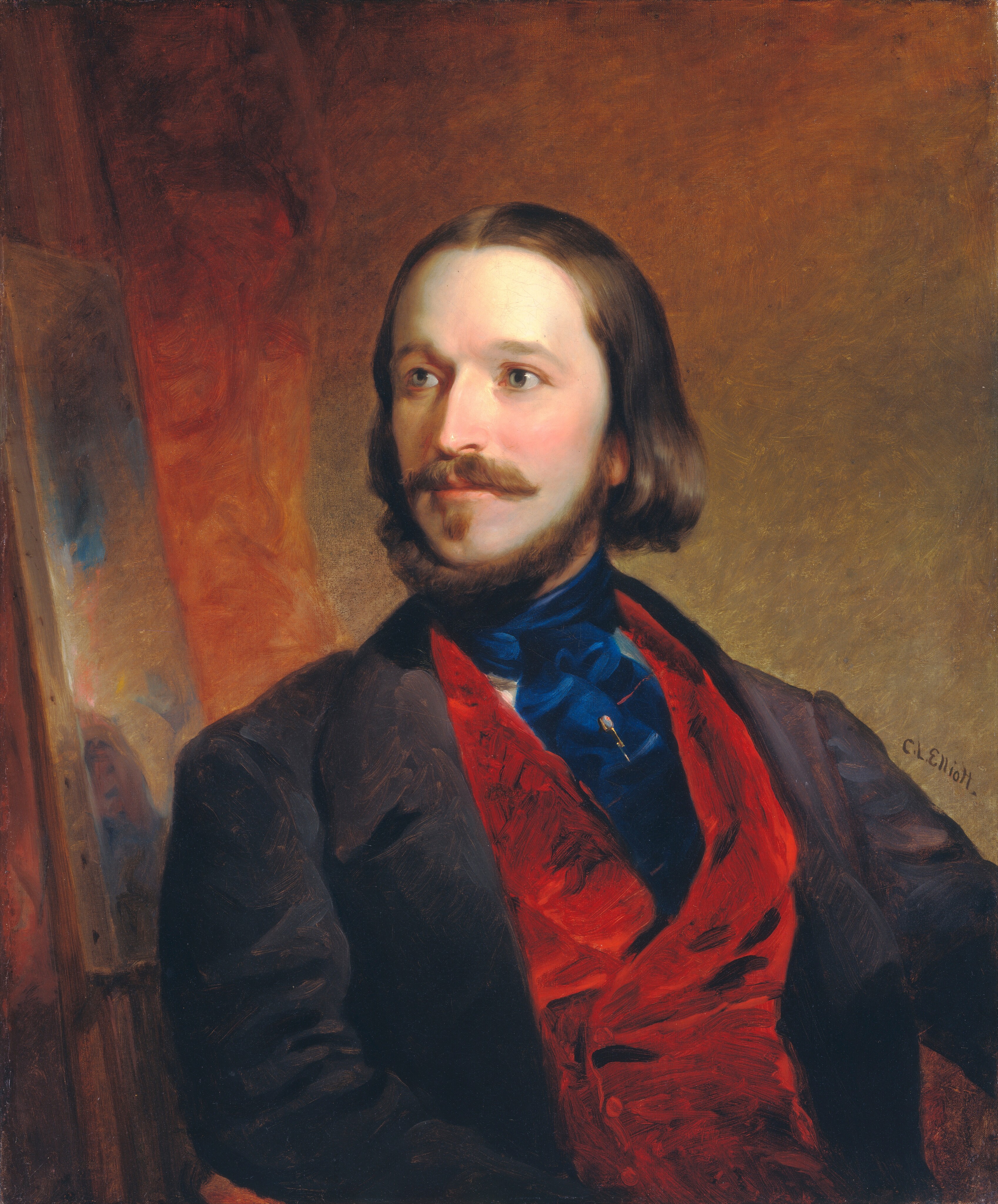 The image shows a person from the waist up, in a seated position with the body slightly angled to the right while the head is turned towards the left. The person has light skin, brown hair that is parted in the middle, and falls to just below the ears, with a distinctive full mustache and beard along the jawline. The person is dressed in a dark jacket over a vibrant red vest and a high-collared blue shirt or tie is visible. A small pin adorns the blue fabric. The background is a textured mix of warm brown tones.