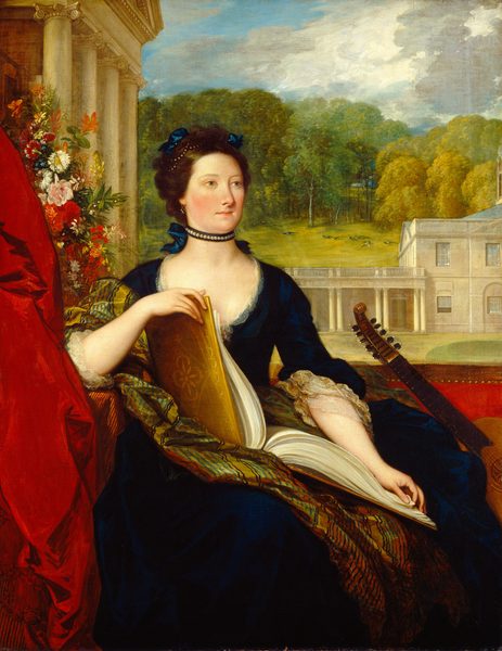 This painting shows a seated woman, her head turned slightly to the right. She has fair skin with rosy cheeks, pale eyebrows, a long nose, and thin pink lips in a neutral expression. Her dark brown hair is in an updo behind her head and adorned with blue ribbons and pearls, and she has a pearl necklace around her neck. She is wearing a dark blue dress with lace details around the low neckline and the wide sleeves. She holds a large open book with a yellow cover on her lap, and there is a guitar-like instrument leaning next to her on the right. On the left is draping red fabric and a cascade of colorful flowers. Behind her in the distance are large, off-white buildings with tall columns and railings, and behind the buildings is a green hill covered with peacocks and leafy trees. The blue sky above is scattered with puffy white and gray clouds.