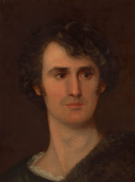 The image is a portrait showing the head and upper part of the torso of a person. The person is positioned with the upper body slightly turned to the side while gazing forward. They have a youthful face with prominent facial features, including deep-set eyes and a straight nose, accompanied by dark, curly hair framing their face. The individual is dressed in a garment that appears to have a dark, textured shawl or wrap over a lighter shirt, visible around the neck area. The background is a plain, dark brown.