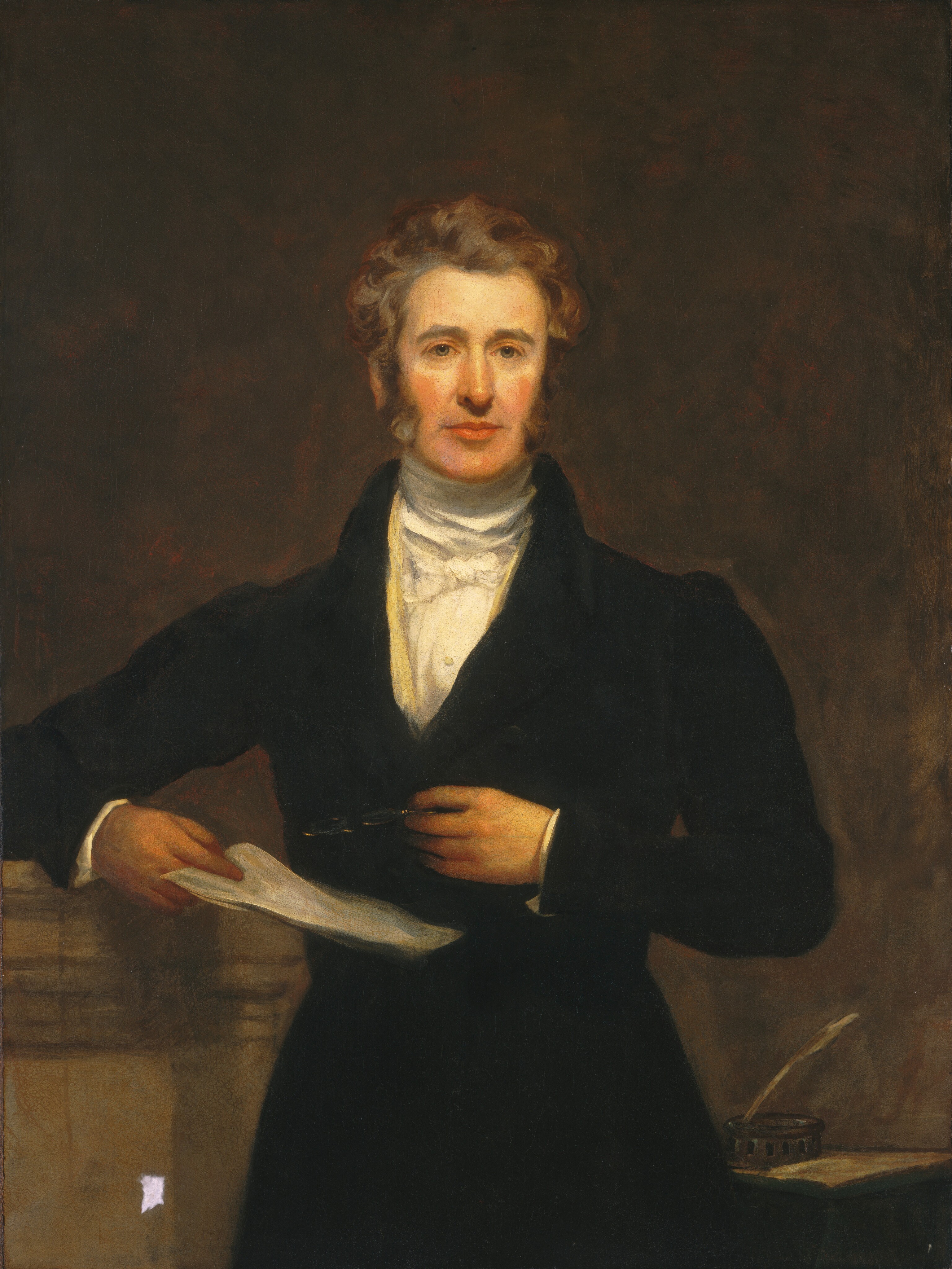 The painting depicts the upper half of a man standing straight and facing us. He has pale skin, rosy cheeks, a long nose, strong brows, and sideburns that lead to his curly, gray-brown hair. He is wearing a black coat over a high-collared white shirt. In one hand he holds papers, while in the other hand he holds a pair of nearly-invisible spectacles against his torso. His right arm is bent and resting on a surface next to him on the left, and there is an inkwell with a quill and a paper on a lower desk or surface on the right. The background is dark brown with some visible brushstrokes.
