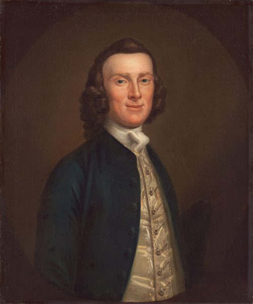 The image depicts a man's upper body, facing slightly sideways towards the viewer. He has distinct facial features with a noticeable nose and a slight smile. He has curled hair framing his face. He is wearing a dark blue coat over a detailed white waistcoat with buttons and embroidery, and a white cravat around his neck. The background is a plain dark brown color.