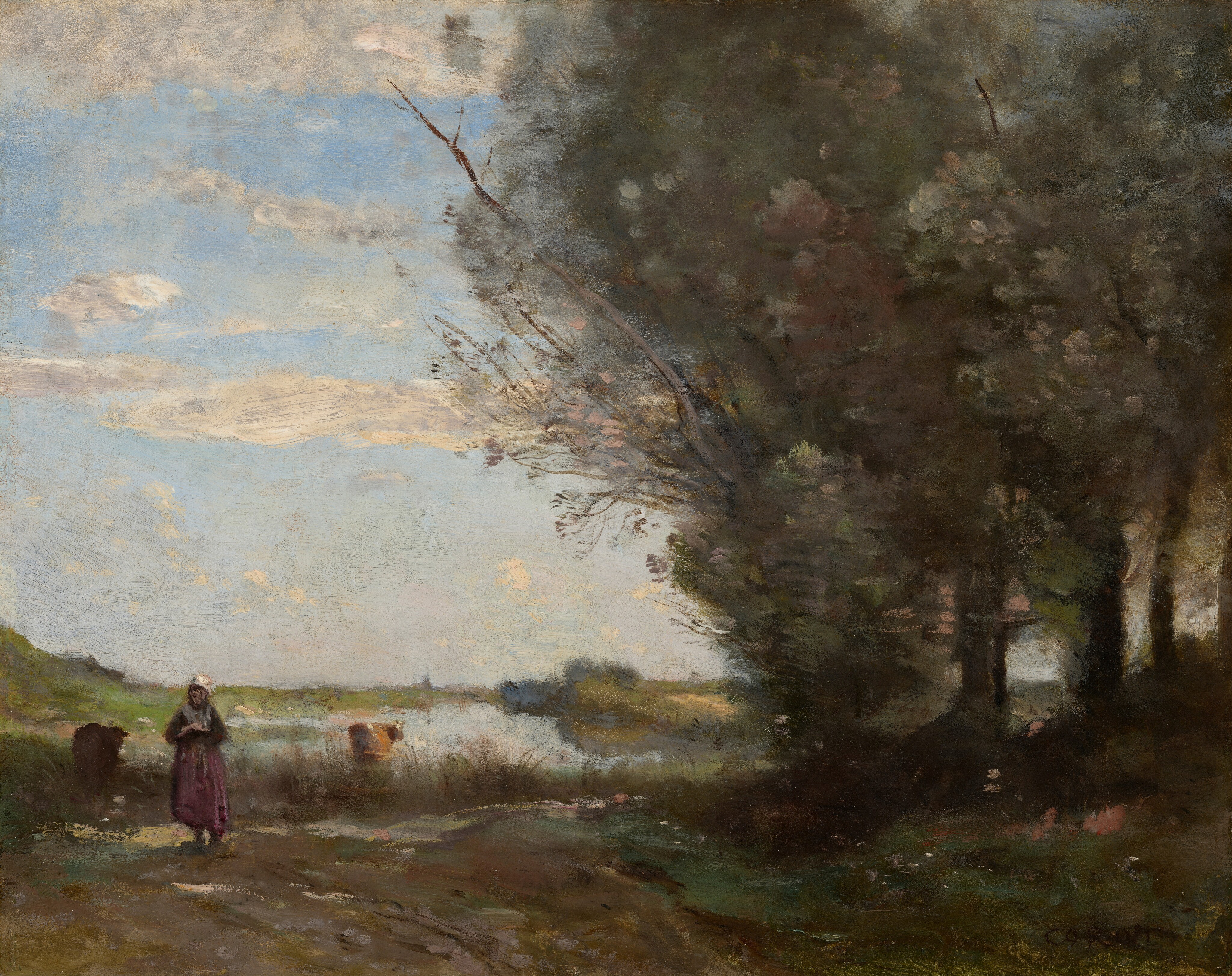 The painting depicts a rural scene with a wide, cloudy blue sky over a riverbank. On the right there are tall, dark green trees that stretch up to the top of the painting. On the left, we see the river stretching into the distance, with a section of grassy ground closer to us. On the left, a woman with a white cloth over her head and a dark pink skirt stands facing us, next to a dirt path framed with tall grass and pale flowers. The woman is painted with loose, visible brushstrokes. To the left and right of her are two shapes that could be cows with their backs to us, both facing the water. The cow on the left is dark brown, while the one on the right is light brown with patches of white, and appears to stand in or right next to the shallow water. The color palette includes earthy tones such as greens, browns, and soft blues. The brushstrokes are visible, giving the scene a hazy look.