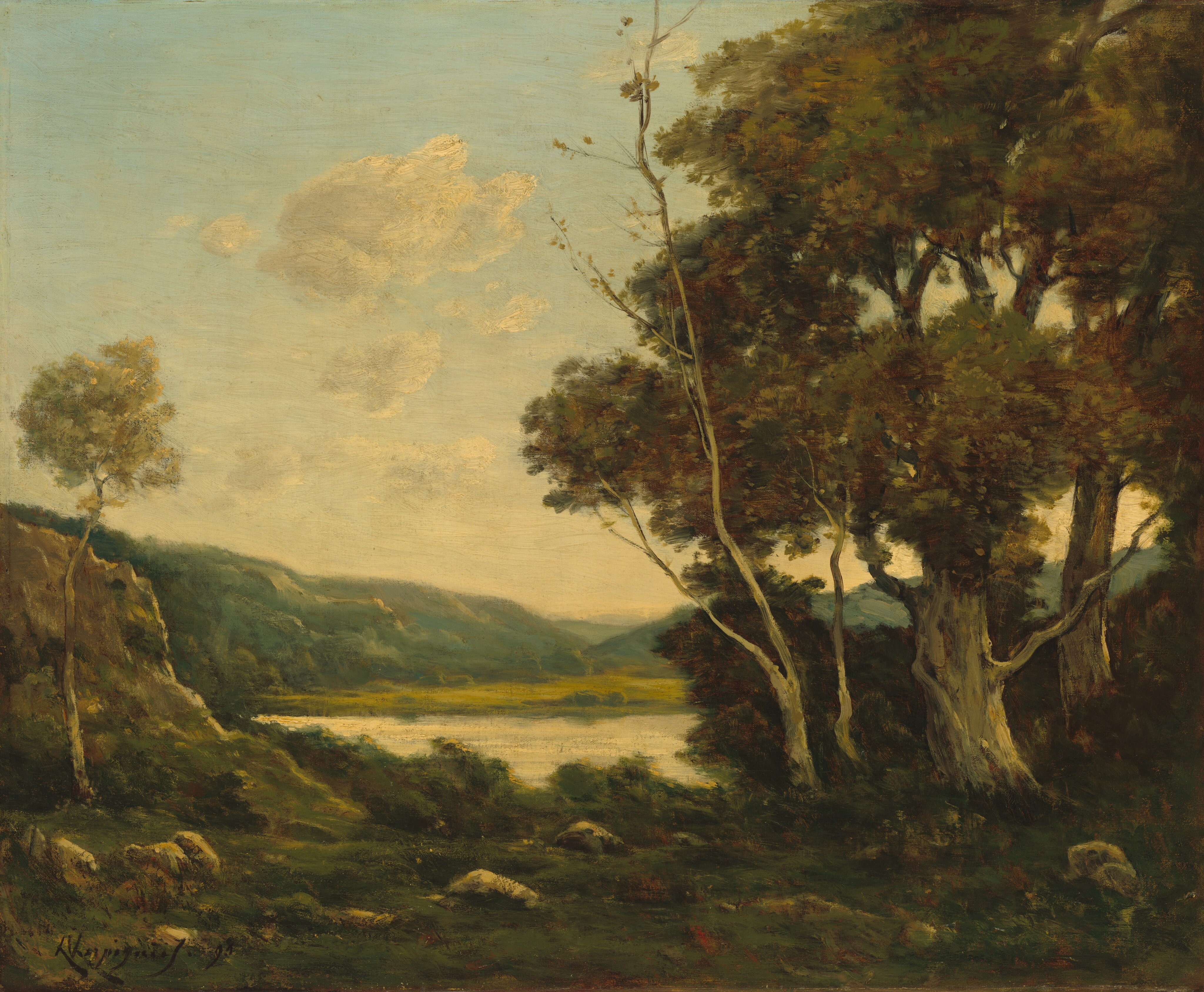 This painting depicts a landscape with a view across a grassy, dark green expanse towards distant hills and a pale gray body of water. Soft clouds fill the pale blue sky above. Tall trees frame the right side of the painting with dark green foliage, and there are small gray rocks across the grass closest to us. Beyond the water are green hills fading into the distance. The color palette includes earthy greens and browns, with soft yellows and blues in the sky and water.