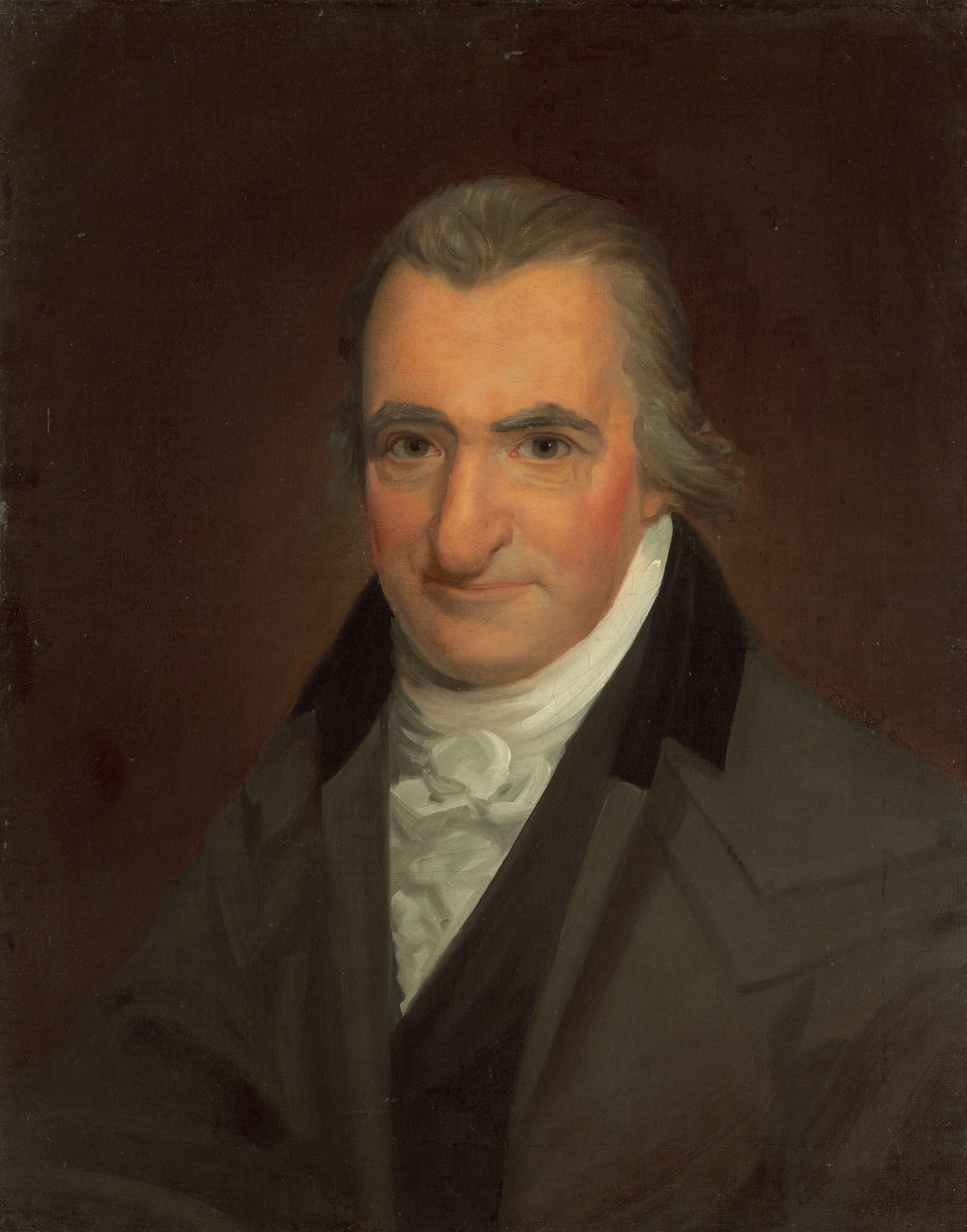 This painting is a portrait of a man. We see him from the chest up in a slightly angled pose, with his body turned slightly to the left and his head facing us. He has light skin, a large nose, thick gray eyebrows, and thin lips turned slightly upwards. His hair is gray and swept back. He is dressed in a dark jacket with a high collar over a white shirt with a cravat. The background is a plain dark brown color.