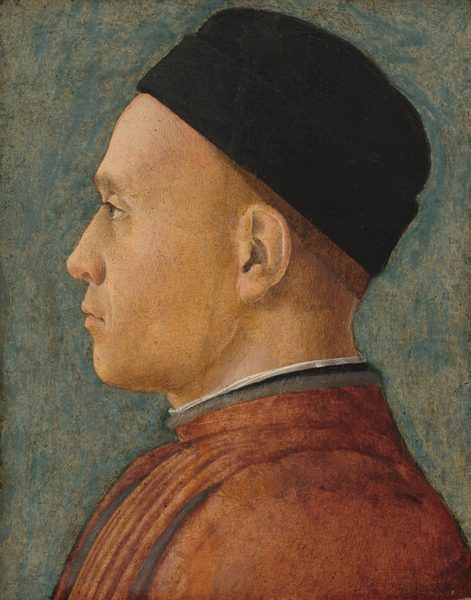 This painting shows a portrait of a man. His head is turned to the left. He has light skin, a straight nose, a soft jawline, and pale lips in a neutral expression. He has closely cropped brown hair mostly covered by a black cap. He wears a red garment with a high gray-and-white collar. The background is a textured, muted blue.