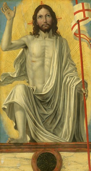 A man draped in a white cloth steps toward us onto a ledge as he holds a red staff with a white banner in one hand and holds up the other hand to show a wound on the palm in this vertical painting. His pale face has a yellow cast but he has rosy cheeks, and his body is eggshell white. Near the upper left corner of the painting, his raised right hand, to our left, is held palm out to show it has been pierced. The cardinal-red staff he supports in his other hand has a long, fluttering banner with a red cross against a white background. He bends his right knee deeply, so his bare foot rests on a low wall or side of a casket in front of him. He looks up with brown eyes under curved eyebrows. He has a straight nose, and his small, rose-pink mouth is closed. He has shoulder-length, brown curly hair and a forked beard. His voluminous ivory-white cloth drapes over one shoulder and hangs in deep folds across the arm holding the banner and the opposite knee. He has a bloody gash over his right ribs. His entire body is surrounded by radiating lines encompassed in a glowing, golden halo. The corners around the halo are celestial blue. The ledge where he props his foot is painted to look like yellow marble veined with gray, framed with fawn-brown molding along the top edge. A round, black medallion flecked with celery green at the front center of the panel is also surrounded with with brown molding.