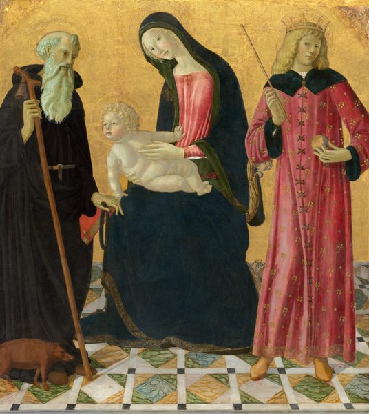 This painting shows four people, three adults and one child. On the left, an elderly man stands, holding a staff in one hand and a red book in the other. He has a long white beard and a balding head, and he wears a black robe. Next to him, in the center, a woman sits, slightly turned to the left and leaning forward, with her hands supporting a child in her lap. The woman wears a red dress with a dark blue hooded cloak, while the child is nude. To the right, another adult stands wearing a pink robe with a crown over their shoulder-length hair, holding a rod and a sphere. All of the people have pale skin, and the three on the right have blond hair. They all have golden halos around their heads. The background is golden, and the floor has a marbled tile pattern. A small brown pig is on the ground at the feet of the old man.