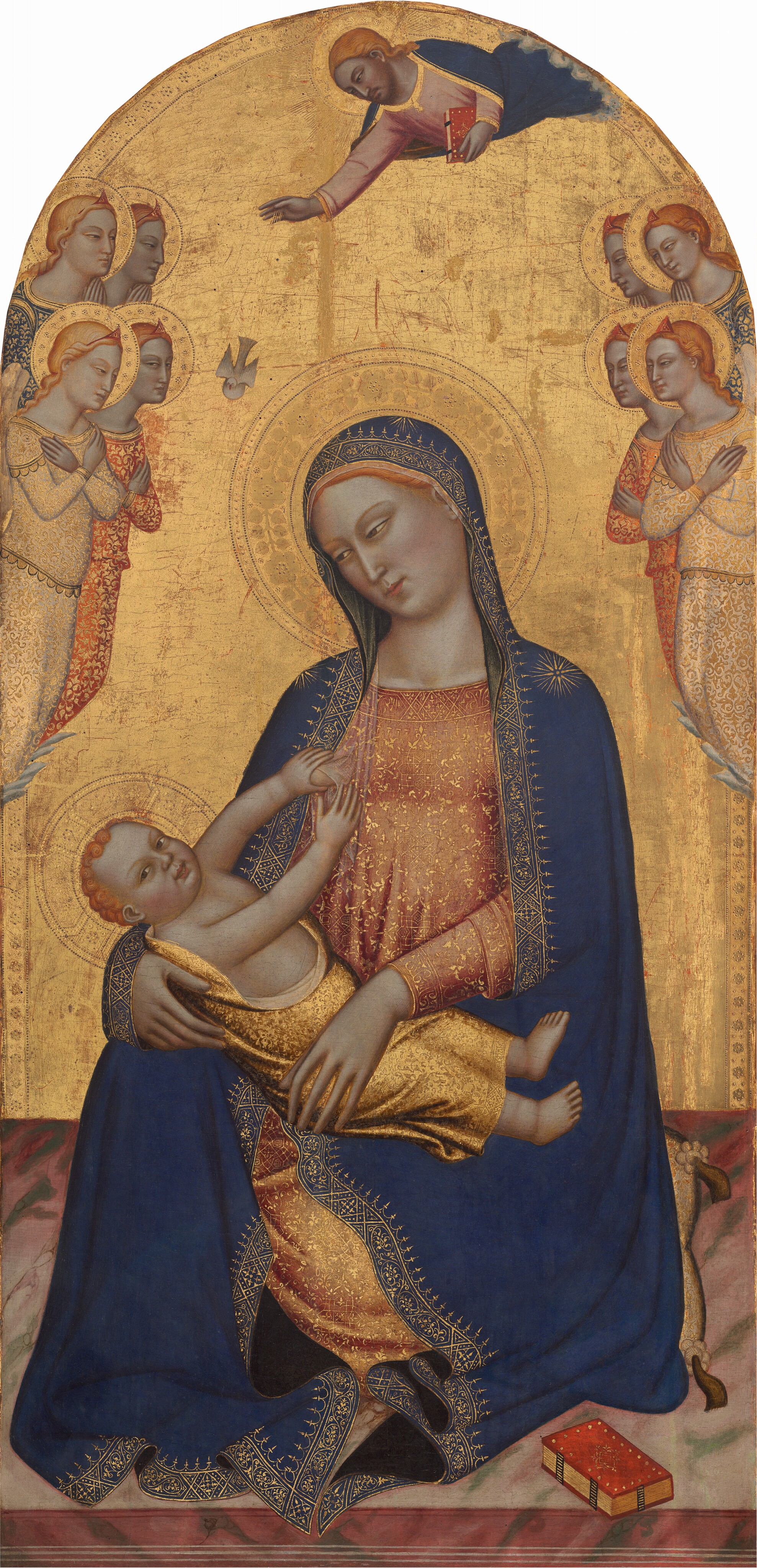 A woman sitting on a pillow on the floor holds a baby stretched stiffly across her lap, and both are shown against a gold background in this arched, vertical painting. Ranks of four winged angels float to each side and a man hovers overhead, above a dove that flies down toward the baby. All the people have light skin, strawberry-blond hair, and their heads are surrounded by gold halos. The woman at the center wears a royal-blue, hooded cloak over a dusky rose-pink dress. The cloak is edged with gold, and there is a gold starburst on each shoulder. Her dress is covered with gold, scrolling vines and geometric patterns. She sits facing us with her head tipped to her right, our left, and she gazes down at  the baby with narrowed, almond-shaped, light brown eyes. She has a long, delicate nose and her small pink lips are closed. The baby has chubby, pink cheeks but his body is more like that of an adult. He lies stiffly across the woman’s lap, wrapped in shimmering gold fabric that leaves his bare feet, chest, and arms exposed. He looks at us as he reaches up and touches the woman’s breast, which emerges from her dress near her right shoulder. He has snail-like curls, medium brown eyes, a rounded nose, and small, pink lips. The pillow the woman sits on has tassels in the corners. The muted pink floor is veined with sage green. A book with a scarlet-red cover and gilded edges sits nearby. On either side of the woman, four winged angels cluster in two rows of two, near the arched top of the panel. The angels all have coral-pink diadems in long blond hair, and they look toward the woman in profile with wrists crossed against their chests or held together in prayer. They wear robes in ivory white, brick red, or royal blue, all decorated throughout with gold patterns. Emerging from a narrow band of clouds to the upper right, a bearded man wearing a blue robe over a pink garment, also both edged with gold, floats above the woman with his right hand extended. He holds a book in his other hand. The white dove below is connected to the man's extended right hand by long lines, like stylized rays of light. Red shows through some cracks and worn areas of the gleaming gold background.
