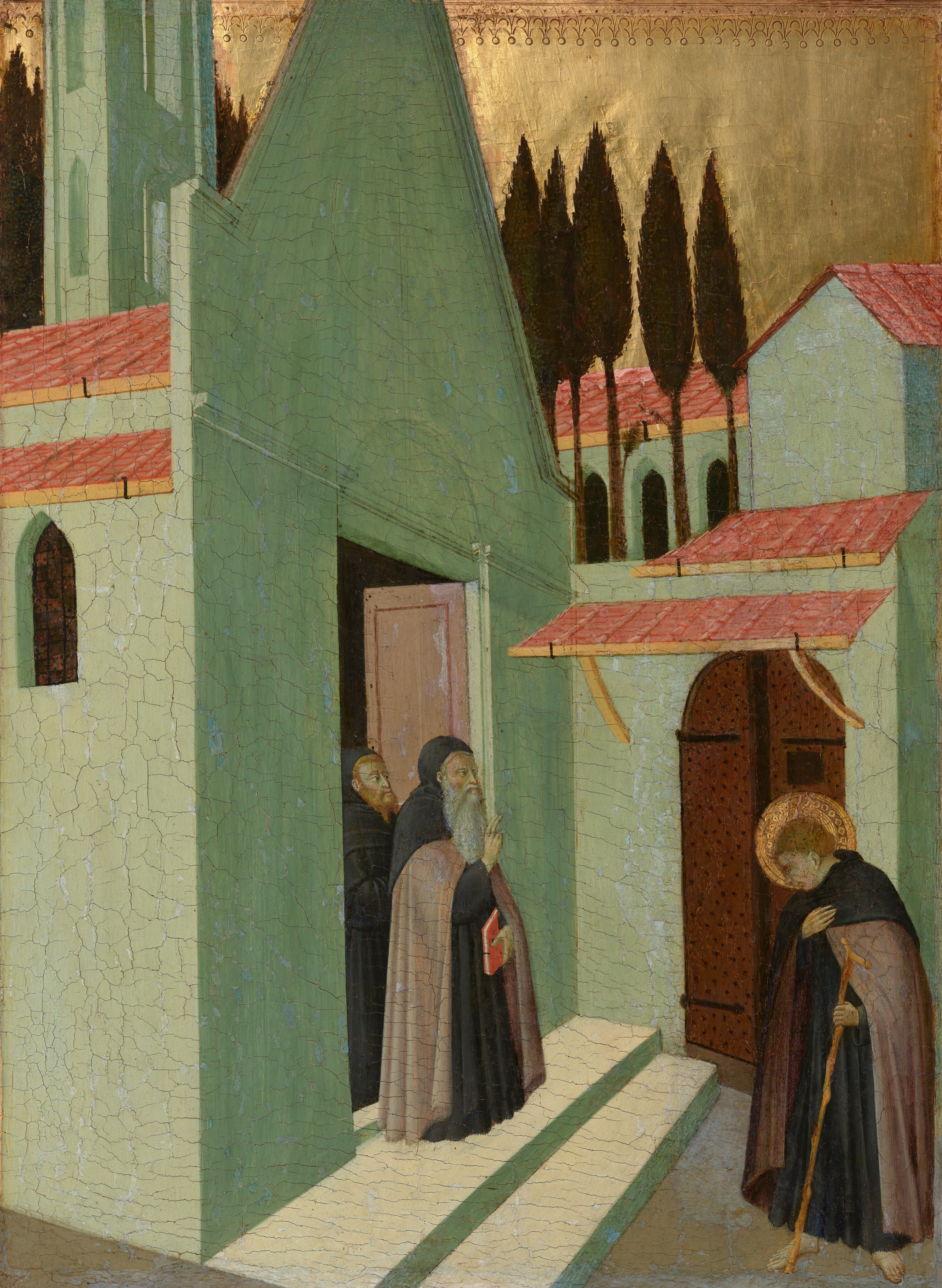 Three pale-skinned men wearing long, dark robes stand in and near a dense cluster of vivid, mint-green buildings with arched openings and clay-red colored roofs that nearly fill this vertical painting. Near the lower center of the composition, two bearded men stand in an open doorway looking out at the younger, cleanshaven man who stands barefoot to our right, facing them. At the door, the man in front has a long, white beard, and he holds a red book, or manuscript, in his left hand while holding up his right hand with his first two fingers raised. The man behind him has a red beard and hair. The younger man to our right bows his head, encircled with a gold halo, toward the pair in the doorway. The younger man holds one hand over his heart, and in the other holds a long, gnarled walking stick. The skin of all three men has a greenish cast. The green buildings are tall and narrow. Beyond the buildings, near the top of the panel, a row of tall, dark green trees are silhouetted against the shiny gold sky. The gold background is punched with a decorative band of small circles and arches along the top edge of the panel.