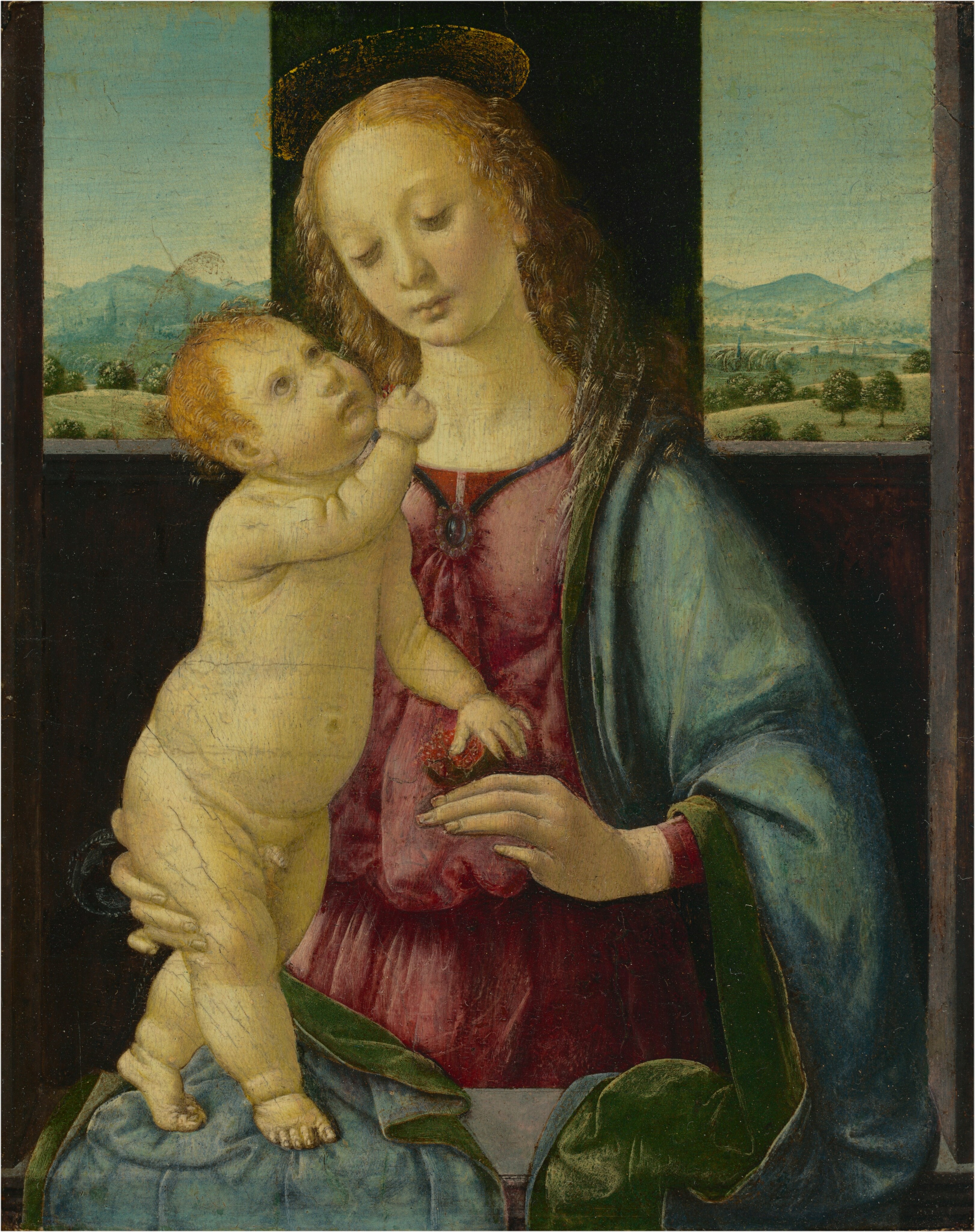 Shown from about the waist up, a woman stands on the far side of a stone ledge, supporting a nude baby boy on the sill in front of her with two more windows opening to distant landscapes behind them in this vertical painting. The bottom and side edges of the stone opening run close to and parallel to the bottom and side edges of the composition. The woman and the baby have pale skin with a yellowish cast, and both have faint gold halos. The woman’s body is angled slightly to our left, and her head tilts to our right as she looks down toward the baby with pale brown eyes. She has a straight nose, smooth cheeks, and her pale, heart-shaped lips are closed. Her blond, curly hair is parted down the middle and hangs to her sloping shoulders. Her mauve-pink dress is gathered at her breast with a midnight-blue jewel, and a lapis-blue cloak with kelly-green lining drapes over her shoulders and across the stone ledge in front of her. Barely noticeable against the deep pink dress, she holds an open pomegranate with ruby-red seeds in her left hand, to our right. With her other hand, she supports the baby behind his legs and backside. His nude, pudgy body is angled to our right as he tilts his head back to look up at the woman with light brown eyes. He has short blond hair and a rounded nose, full cheeks, and his lips are slightly downturned. With his right hand, closer to us, he holds a few pomegranate seeds up near the woman’s face. His other hand rests on the fruit by the woman’s torso. The child stands with one foot in front of the other on the cloak draped over the gray stone sill. Two rectangular windows pierce the back wall of the shallow, shadowed room behind the pair, with one over each of the woman’s shoulders. Grassy fields are dotted with trees, flowers, and bushes, and lead back to powder-blue hills in the deep distance. The light blue sky fades to pale yellow along the horizon.