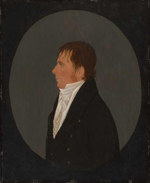 The image shows a portrait of a man from the chest up, in a side profile position facing left. He has a fair complexion with distinct facial features, including a straight nose and a strong jawline. His hair is brown and styled casually. He is wearing a black coat over a white high-collared shirt with ruffles. The background is a solid, muted gray tone.