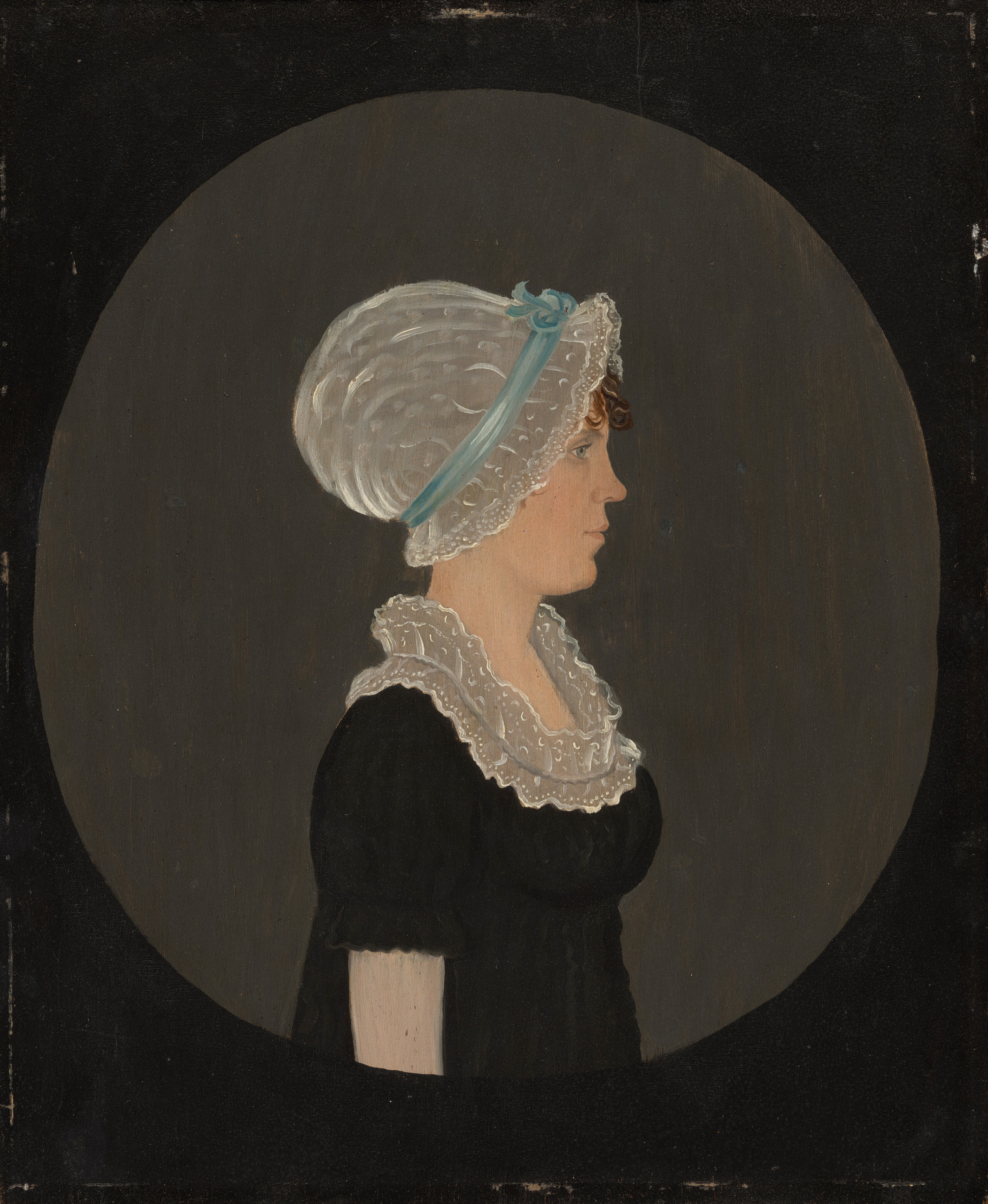 The image shows a woman in profile. She is seated with her torso turned slightly to the left. Her facial features include a straight nose, closed lips, and she wears a lace cap with a blue ribbon. Some brown curls peek out from under the cap. She wears a dark dress with short sleeves and a white lace collar. There is no visible jewelry or objects in her hands. The background is a solid dark circle against a neutral backdrop.