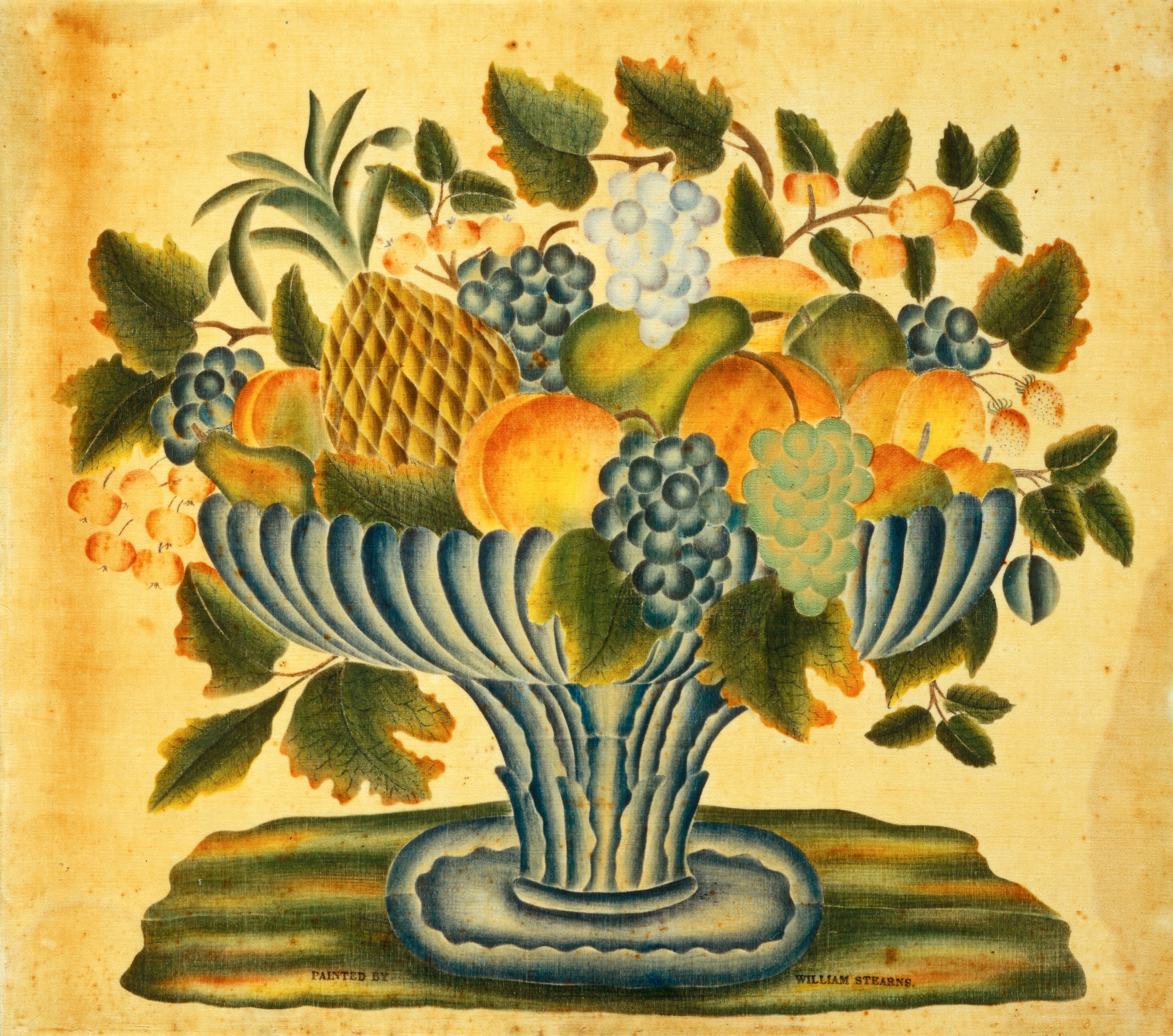 The image shows a large blue and grey bowl filled with various fruits, including grapes, peaches, and a pineapple. The color palette consists of blues, greens, yellows, oranges, and browns. The bowl is placed on a surface with the fruits and foliage overflowing in all directions.