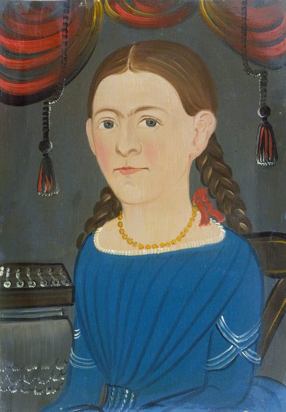 The image shows a portrait of a person from the waist up. The individual is seated and facing forward. They have light skin, large eyes, and subtly colored cheeks, with hair neatly parted in the middle and braided, secured with a red ribbon. The person is wearing a blue garment with a white neckline and white accents on the sleeves. Around their neck is an orange beaded necklace. The background features an interior setting with a vertical wood texture, flanked by red and gold drapes adorned with tassels. To the left, there is a partial view of a musical instrument on a table.